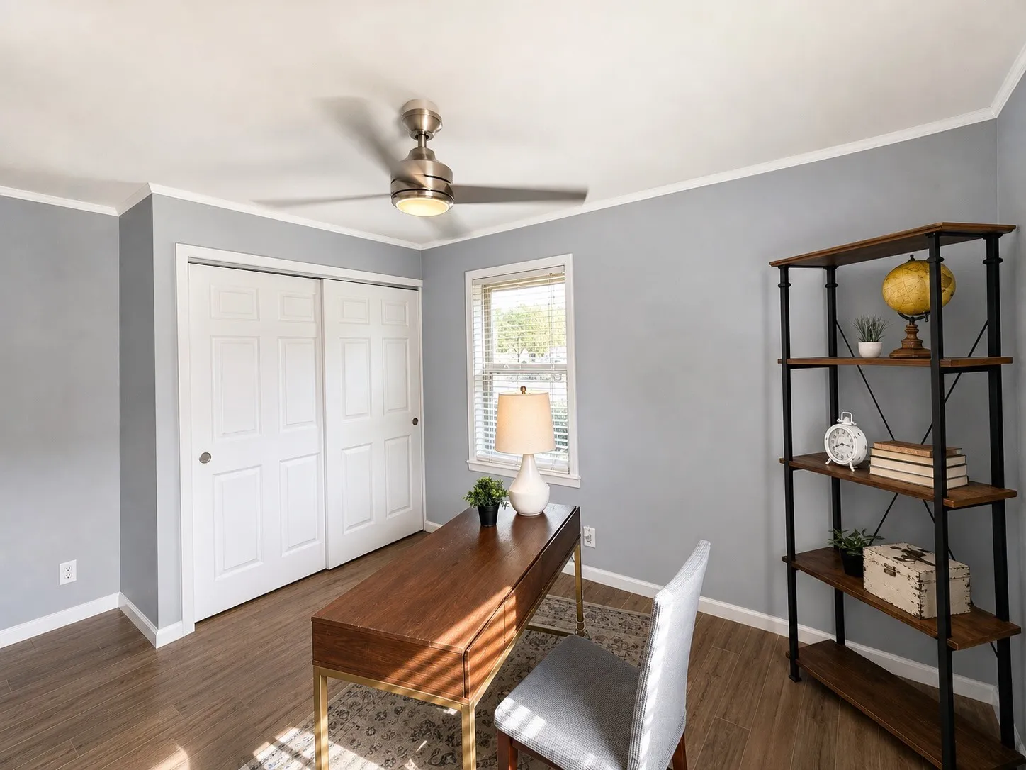 Wood-finish flooring with crisp white baseboards and crown molding