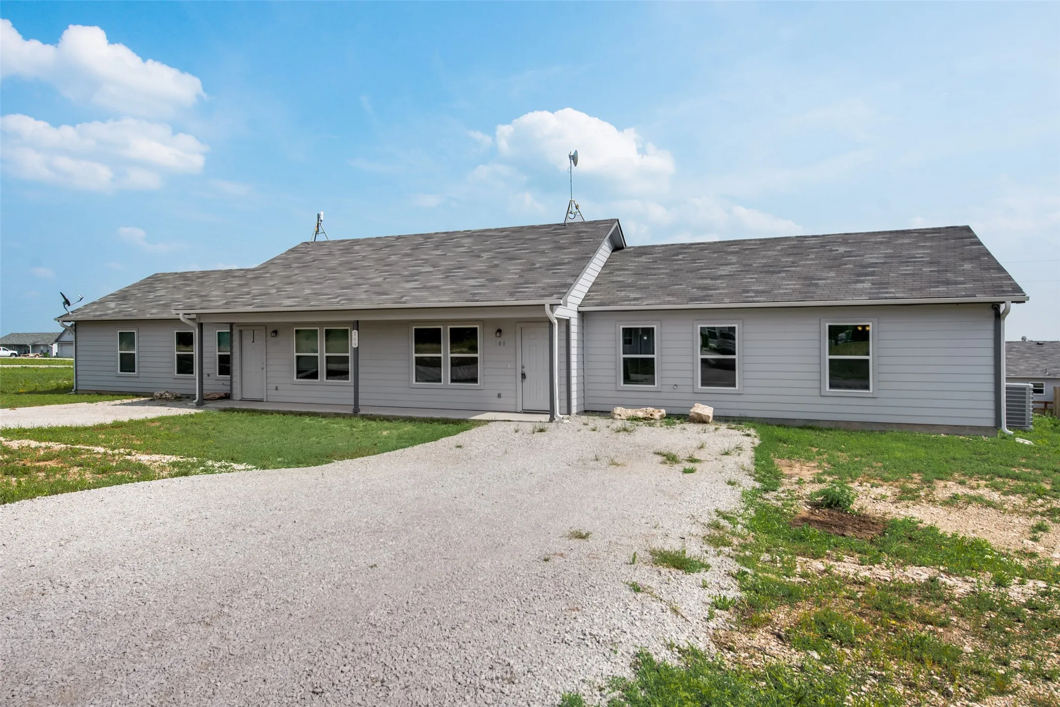 Light gray siding exterior with a dark gray shingle roof