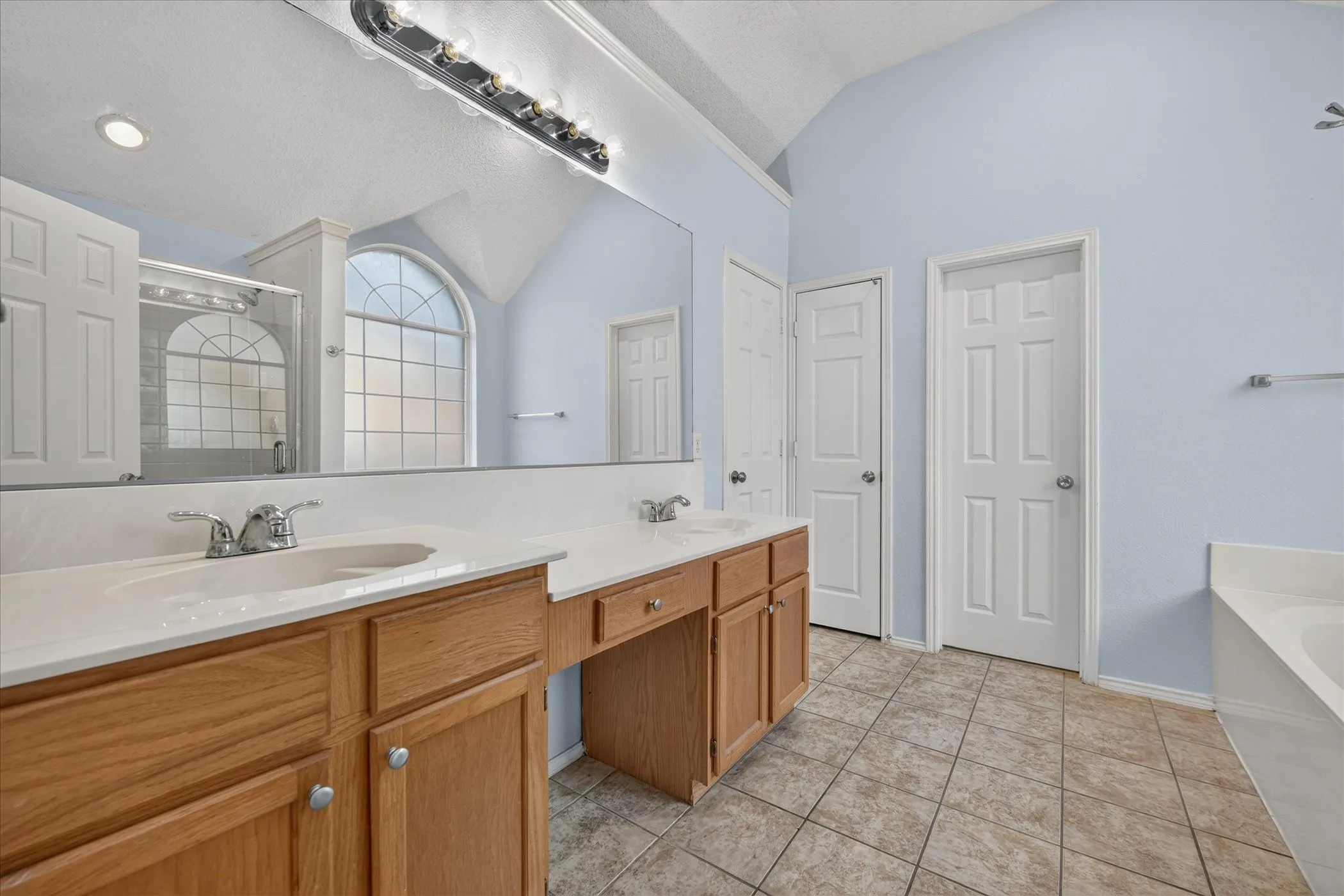 Dual vanity with integrated sinks and wood-finish cabinetry