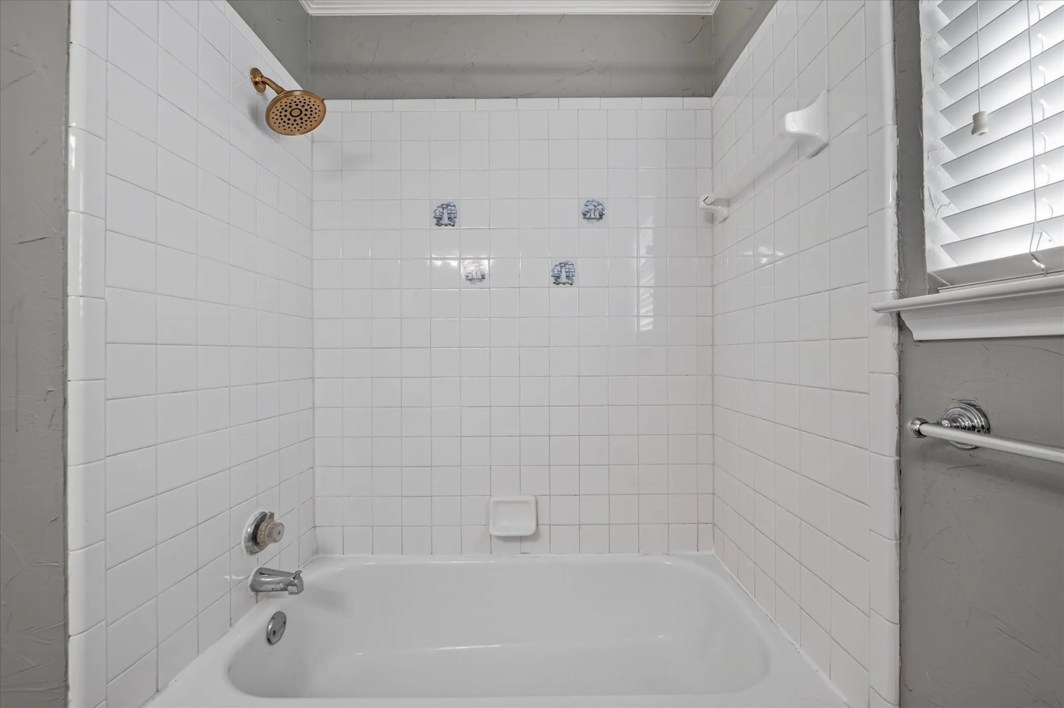 White tiled shower surround with an integrated tub