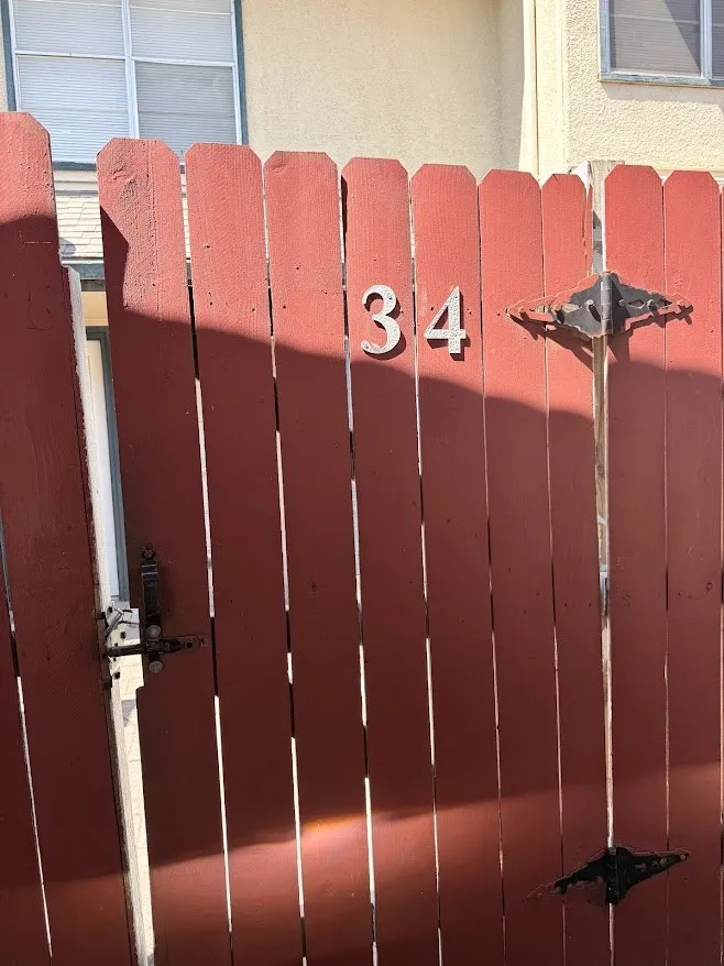 Enter to his gate towards the backyard