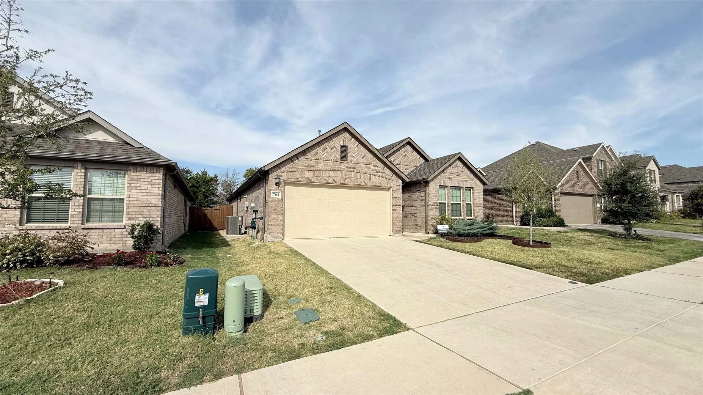Brick exterior with an attached two-car garage