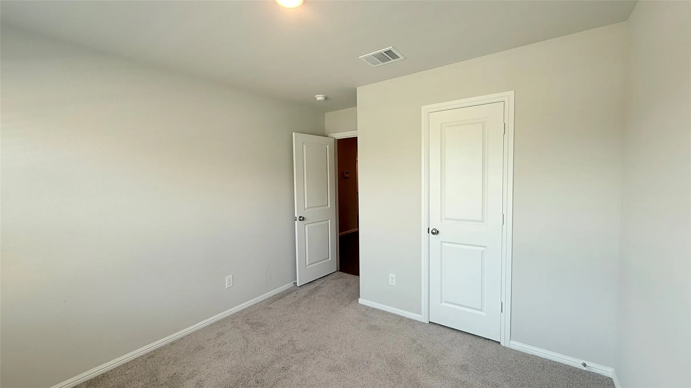 Dedicated laundry area featuring a wall-mounted shelving unit with a hanging rod