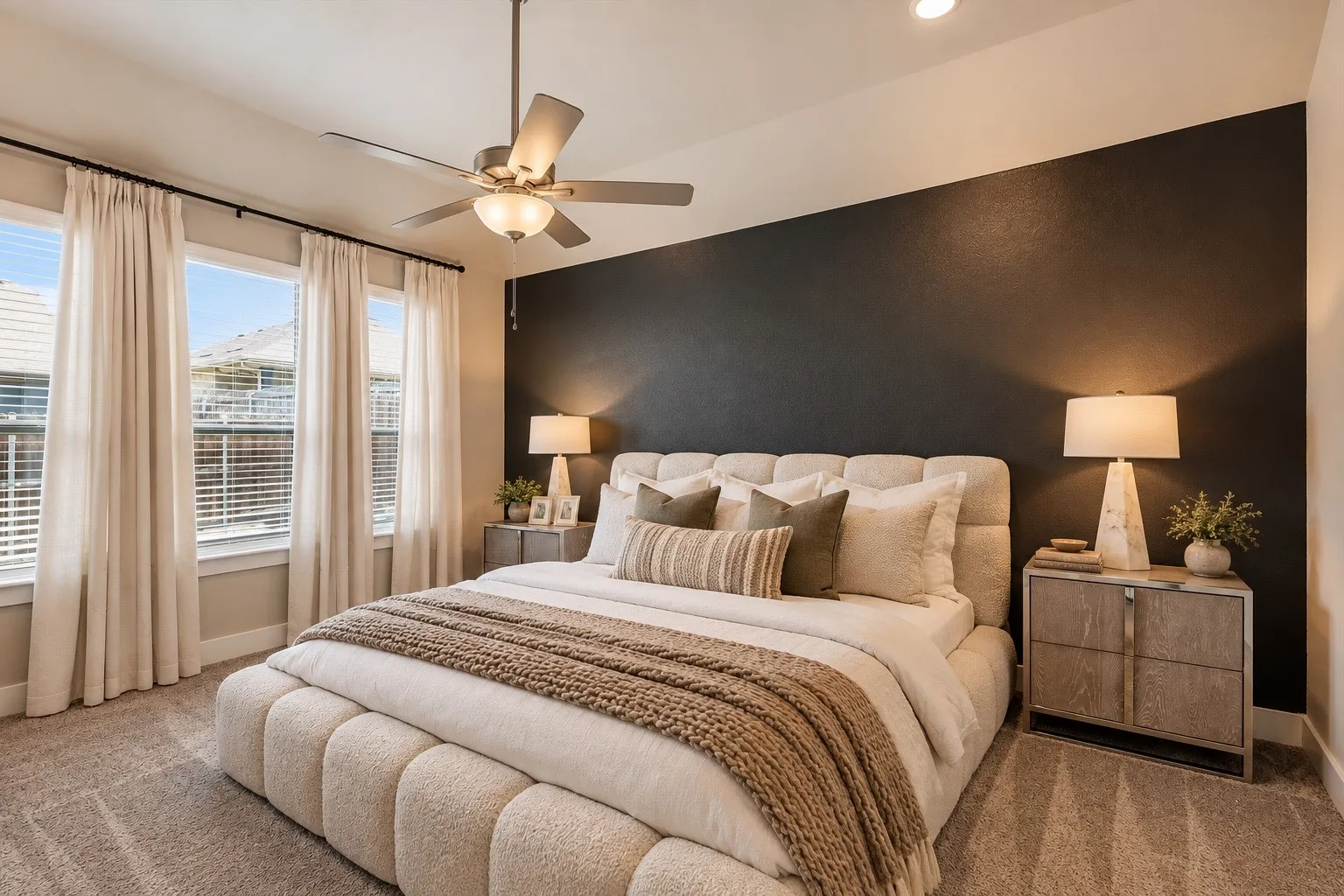 Secluded primary suite offering a peaceful retreat with abundant natural light, plush carpeting, and a spacious, relaxing atmosphere designed for comfort and privacy.