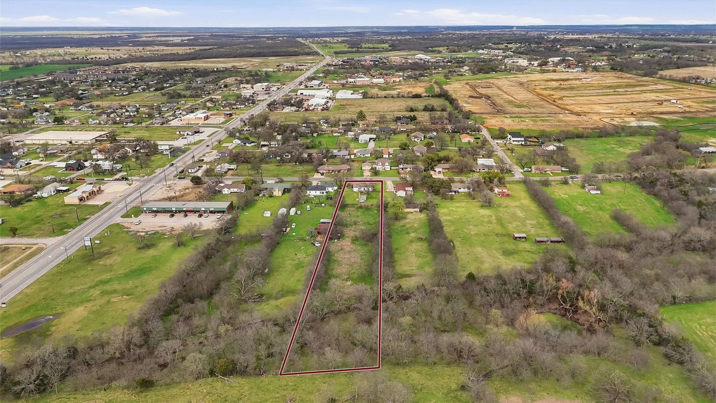 Expansive lot featuring a natural, undeveloped landscape and established tree coverage