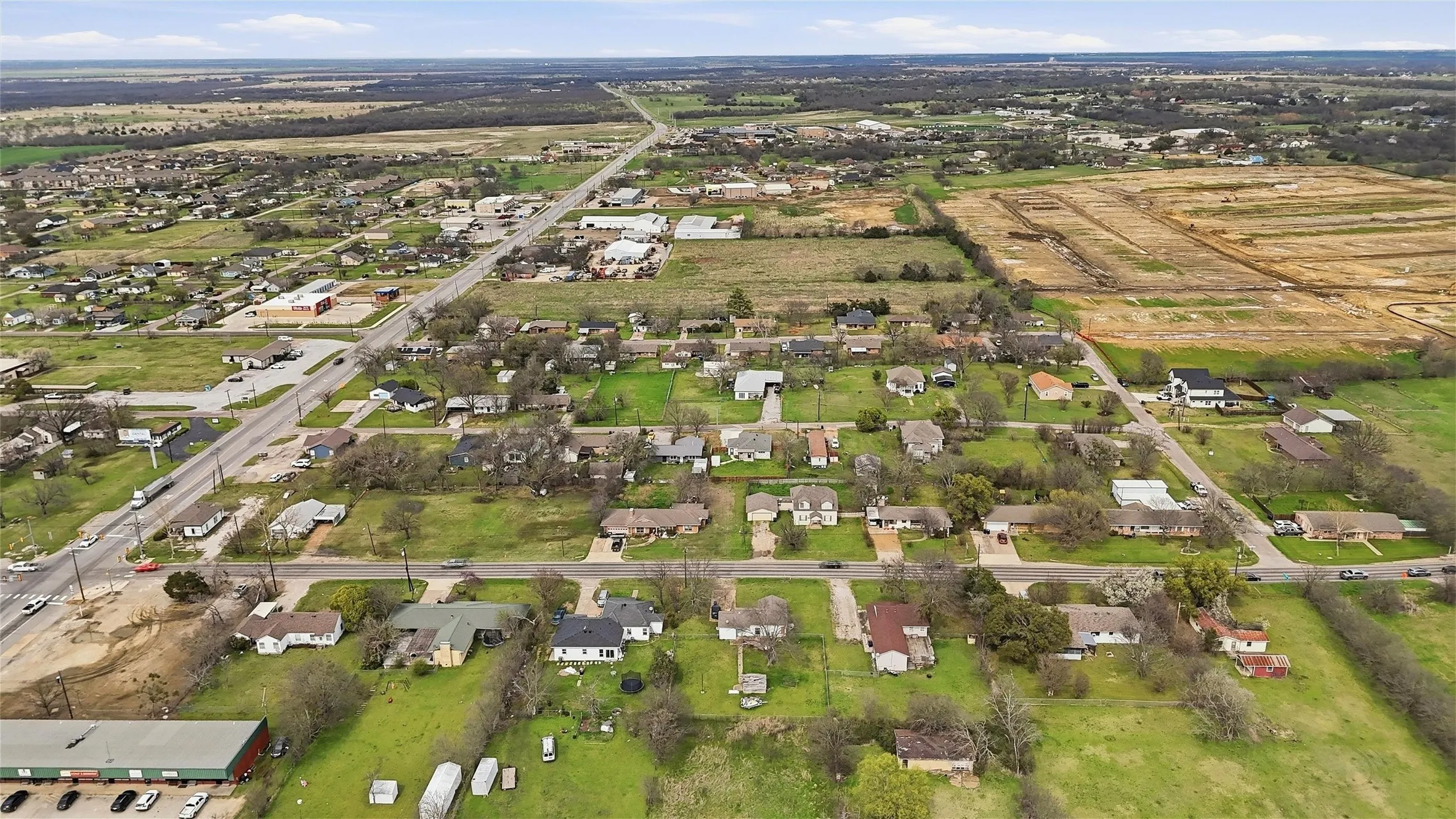 Expansive rural landscape with residential properties and developed roadways