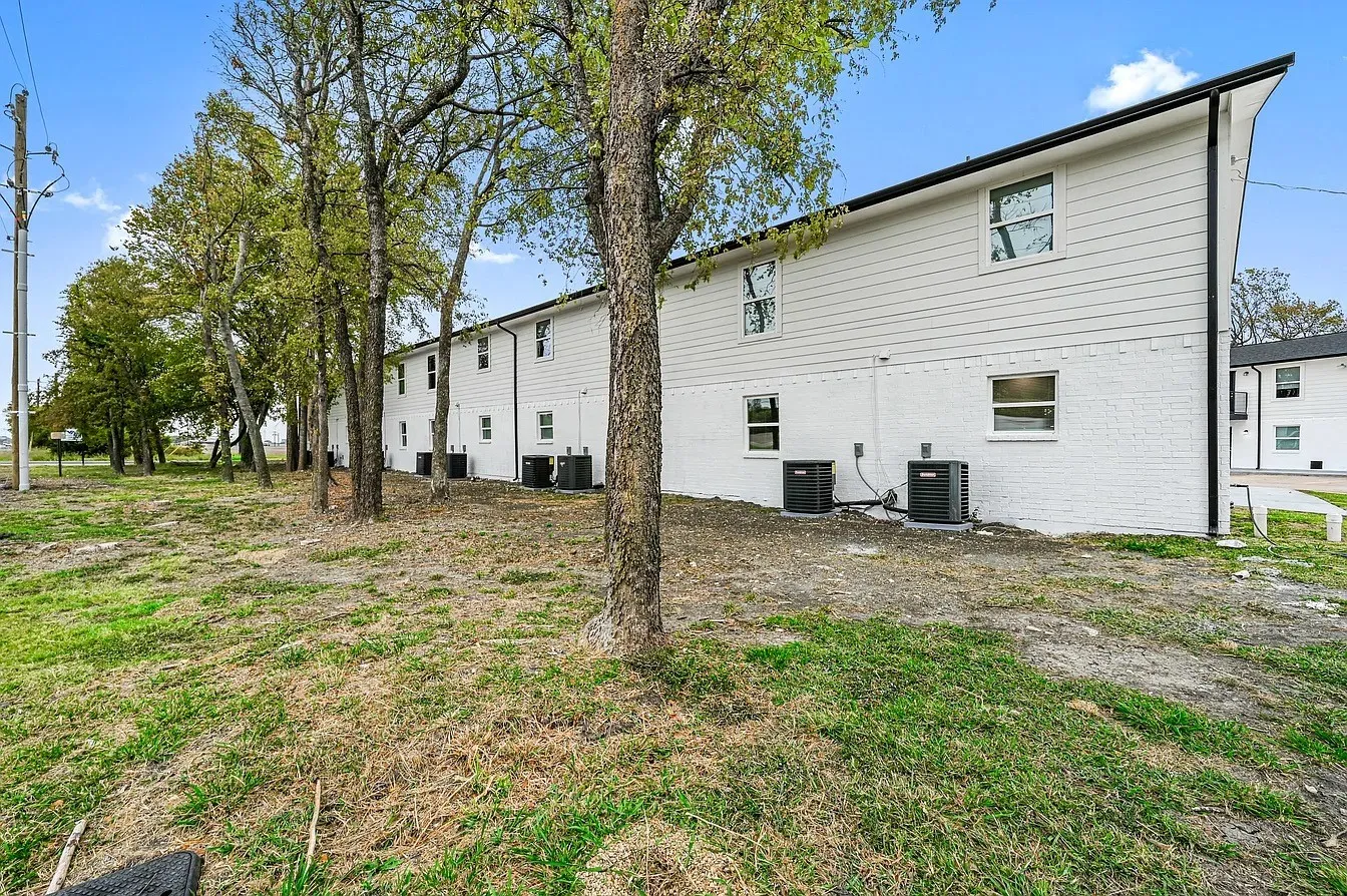 Contemporary multi-unit exterior with white siding and a black roofline