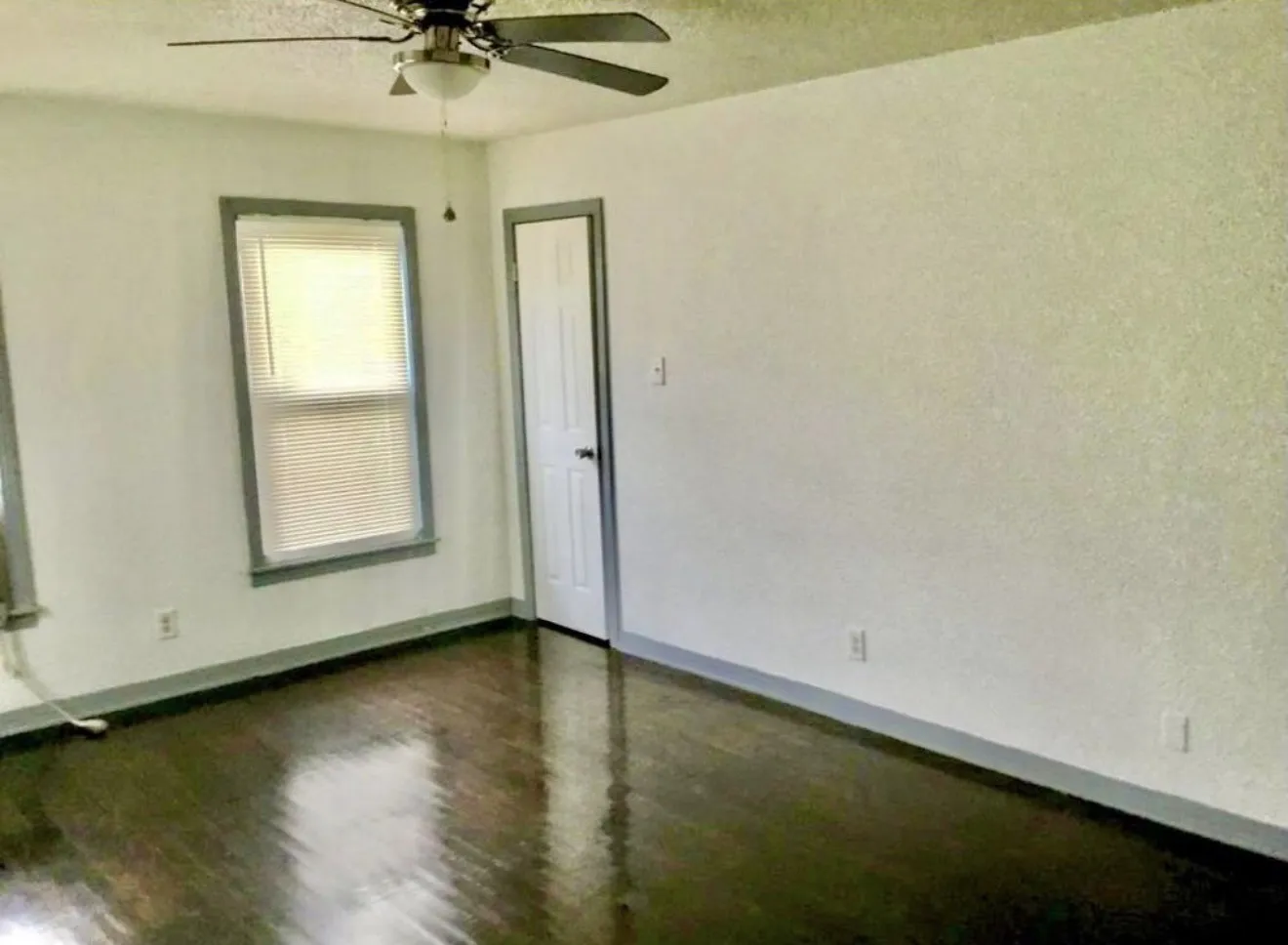 Bedroom with Hardwood flooring, ceiling fan with light, natural light and separate exit to front porch.