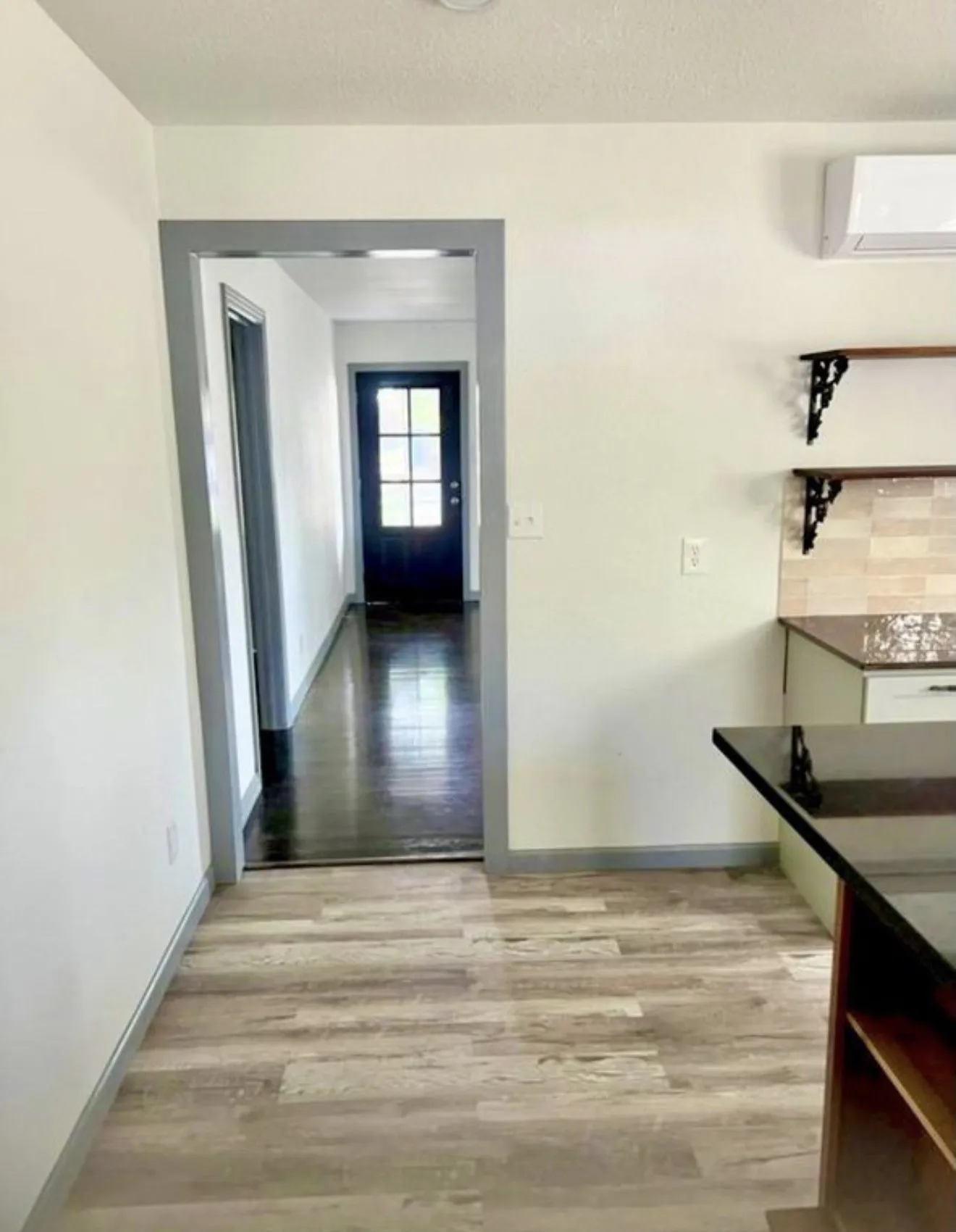 Entrance into the kitchen. Front door in the distance.