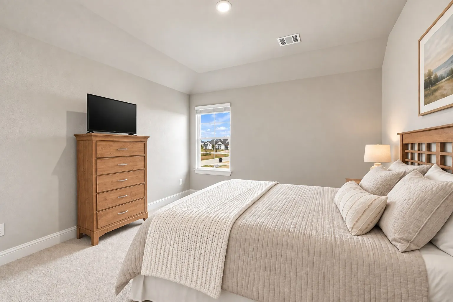 Vaulted ceiling with recessed lighting, single window with roller shade, and light-toned wall finishes