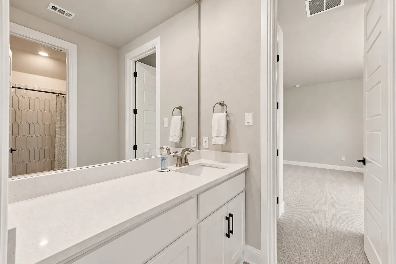 Vanity with a white countertop and integrated sink