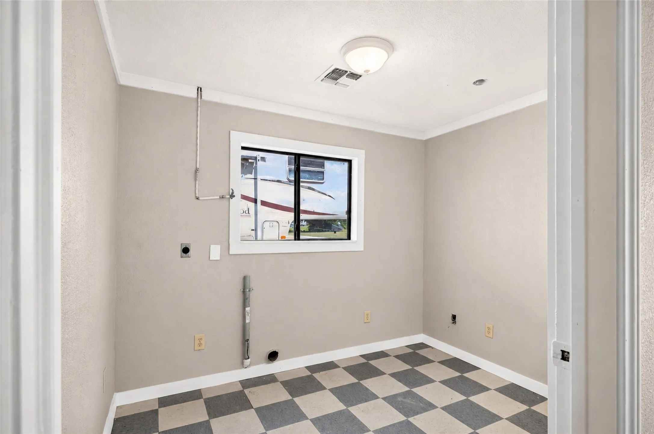 Room featuring checkerboard flooring, a window with white trim, and crown molding