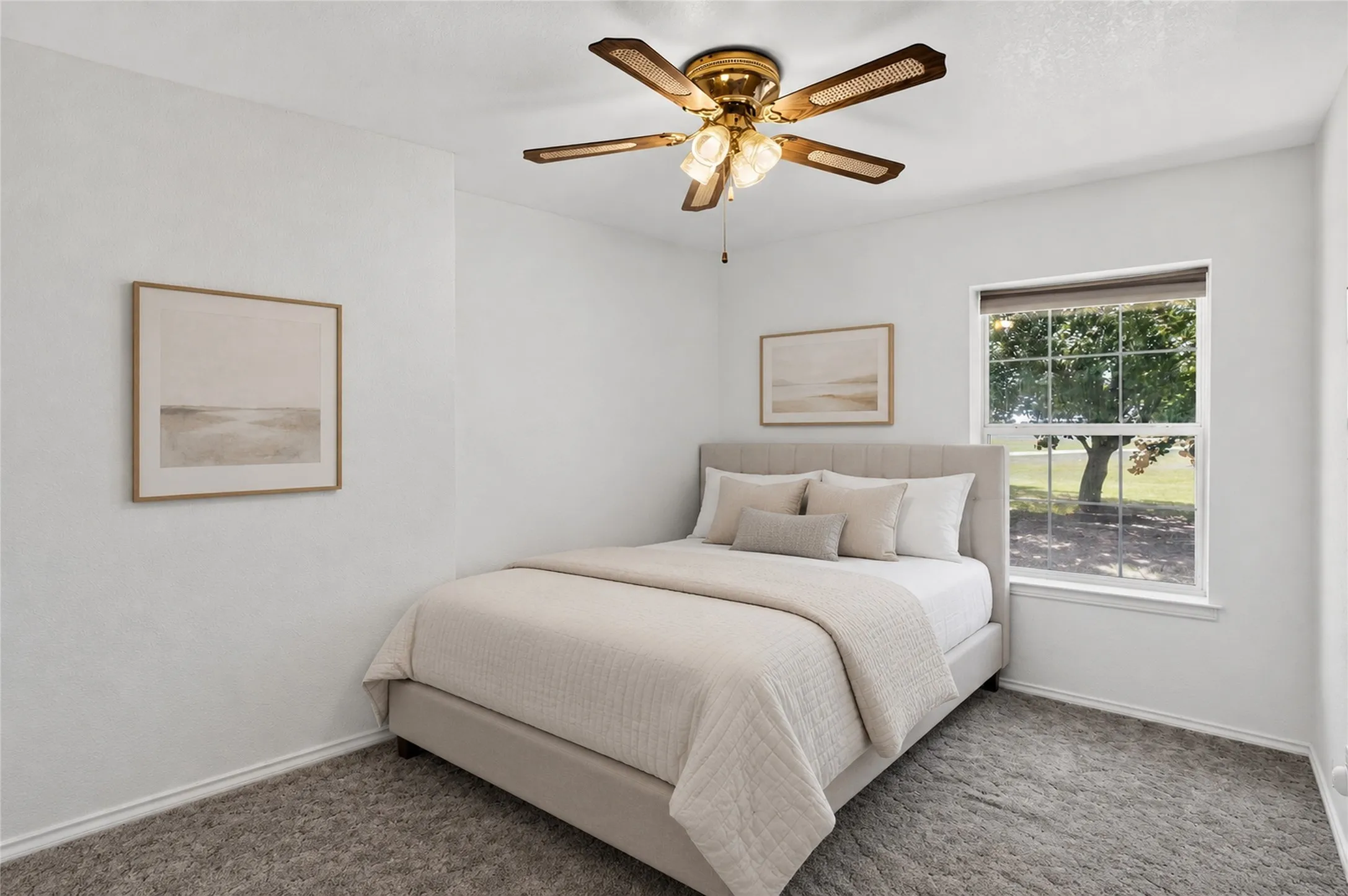 Window with exterior views, textured carpet flooring, and a ceiling fan with integrated lighting - Virtually Staged
