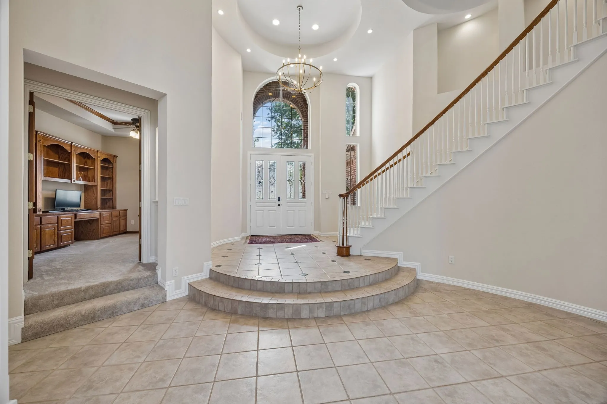 Looking back toward the entry, notice the curved lines of the entry and the striking light fixture. The study with handsome built-ins is just off the entry - perfect for work from home.