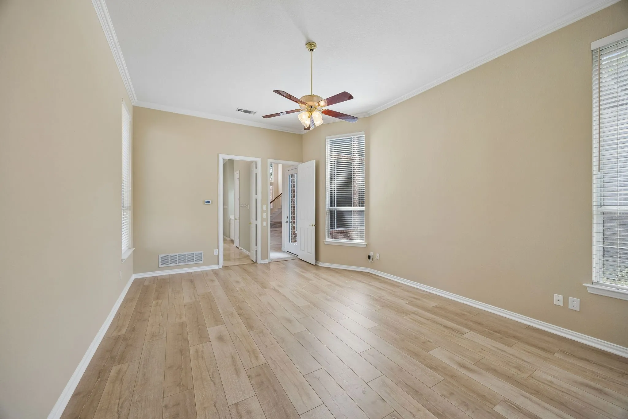 Features of the primary include en suite bath, large walk-in closet, ceiling fan, LVP flooring. Find backyard access through a doorway in the hall leading to the primary.
