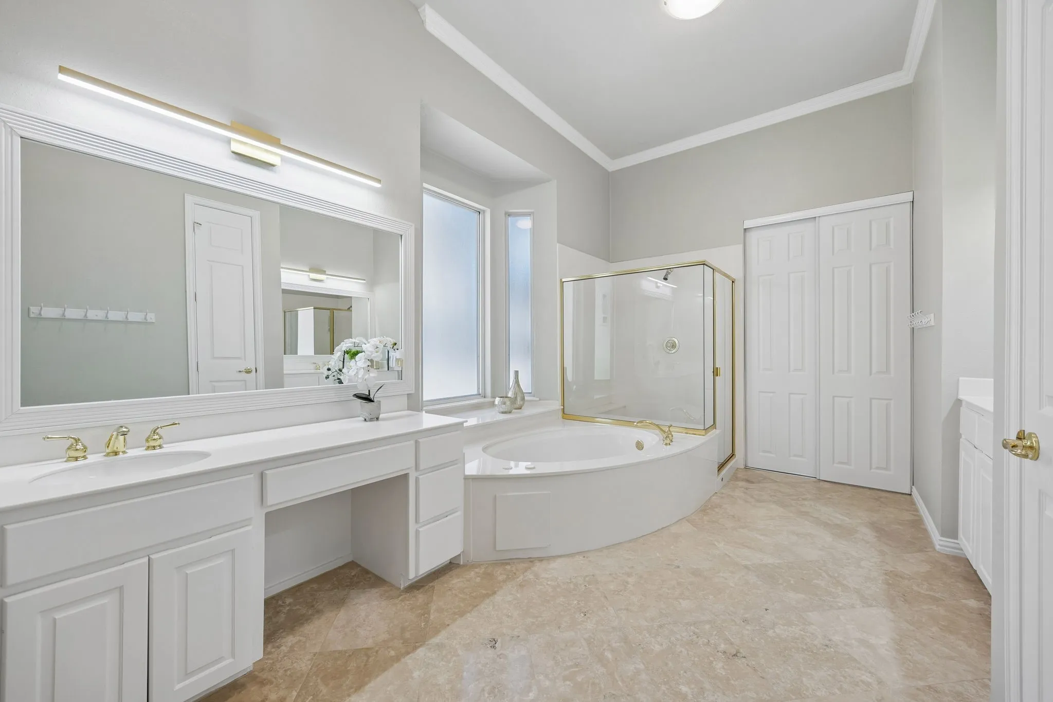The en suite primary bath has dual vanities, framed mirrors, jetted tub and separate shower.
