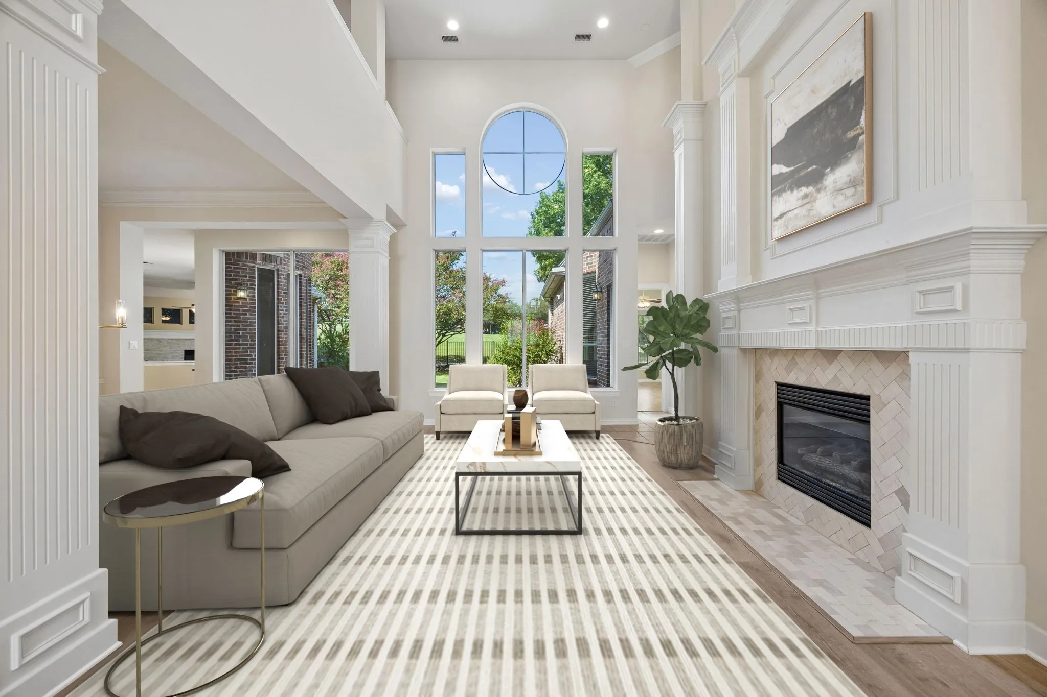 The elegant formals enjoy beautiful views through the wall of windows. The living room is anchored by the tasteful fireplace with white millwork, herringbone tile surround and gas logs. Graceful pillars with crown moulding complete the space. Luxury vinyl plank flooring runs through much of the first floor. (Virtually staged to show potential.)