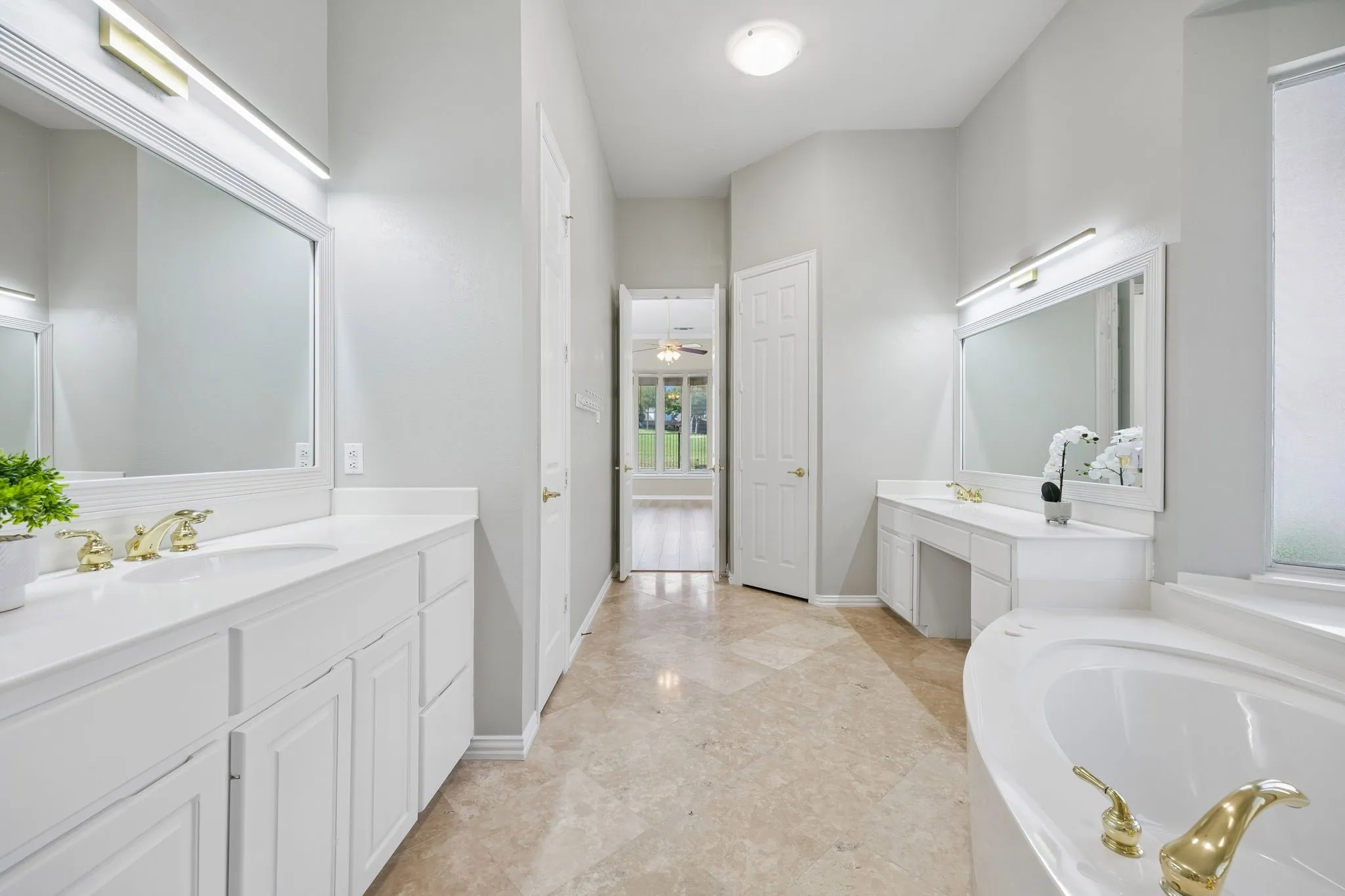 The primary bathroom offers nice storage including a small linen closet. The separate water closet is through the doorway shown on the right.