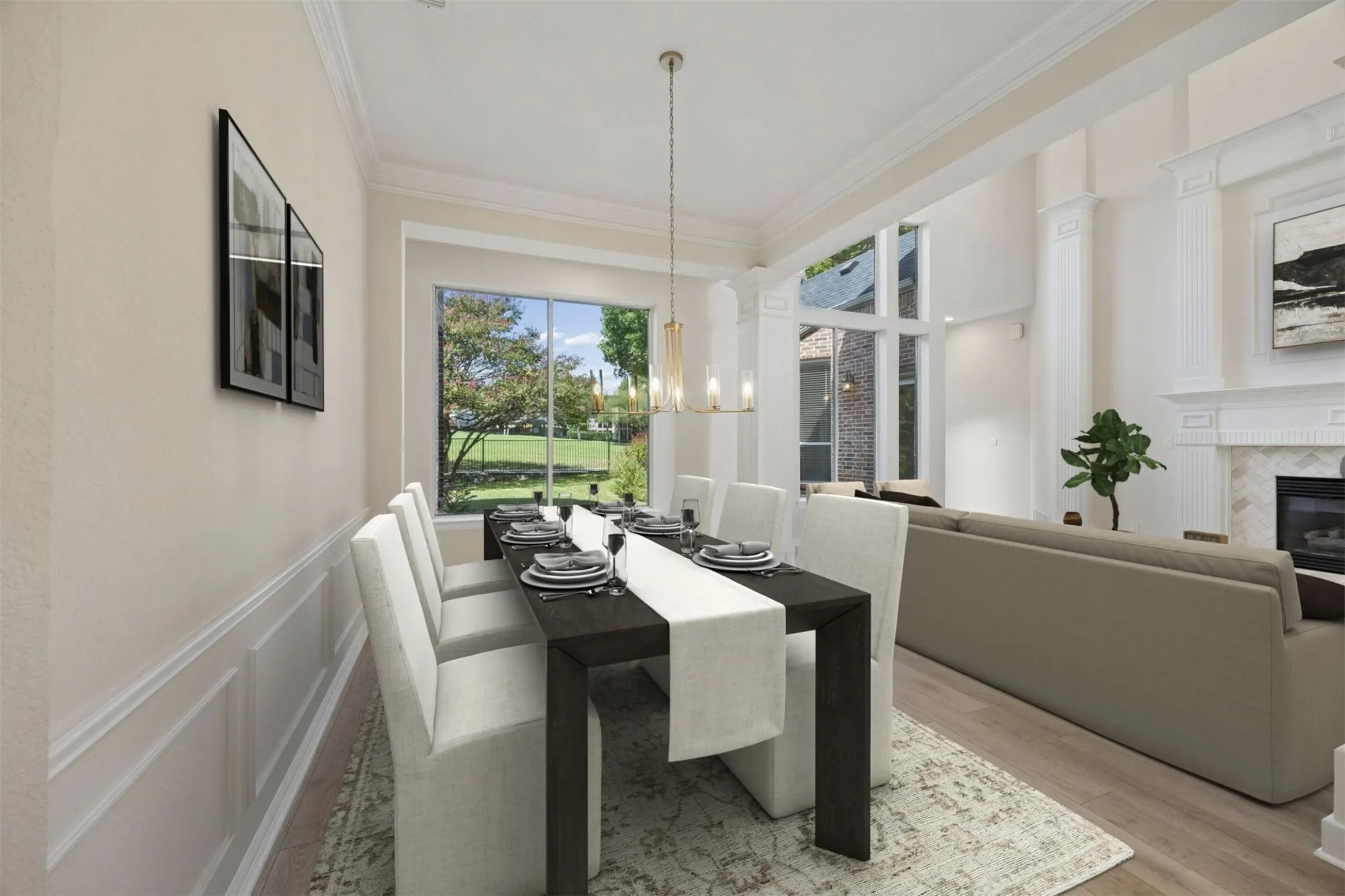 Features of the formal dining space include wainscotting, crown molding and stylish light fixture.