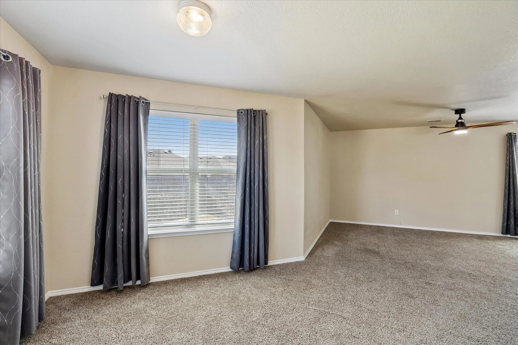 Primary bedroom upstairs with an extended sitting area.