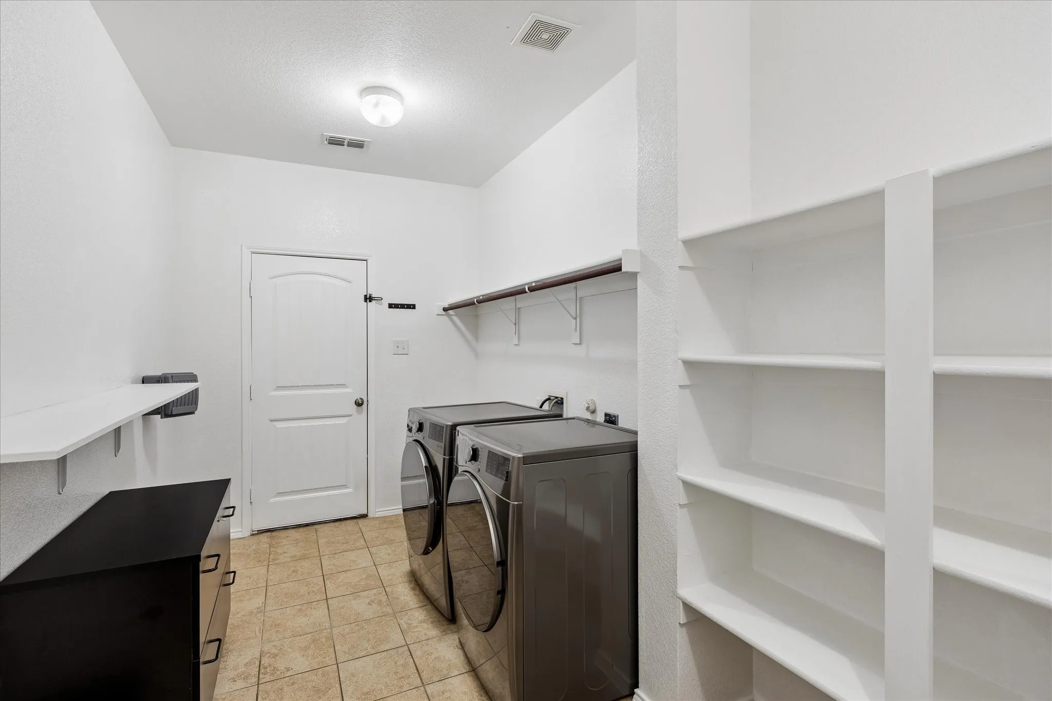 THIS pantry and utility room is quite large and has much storage space.  Right off the kitchen and through to the garage.