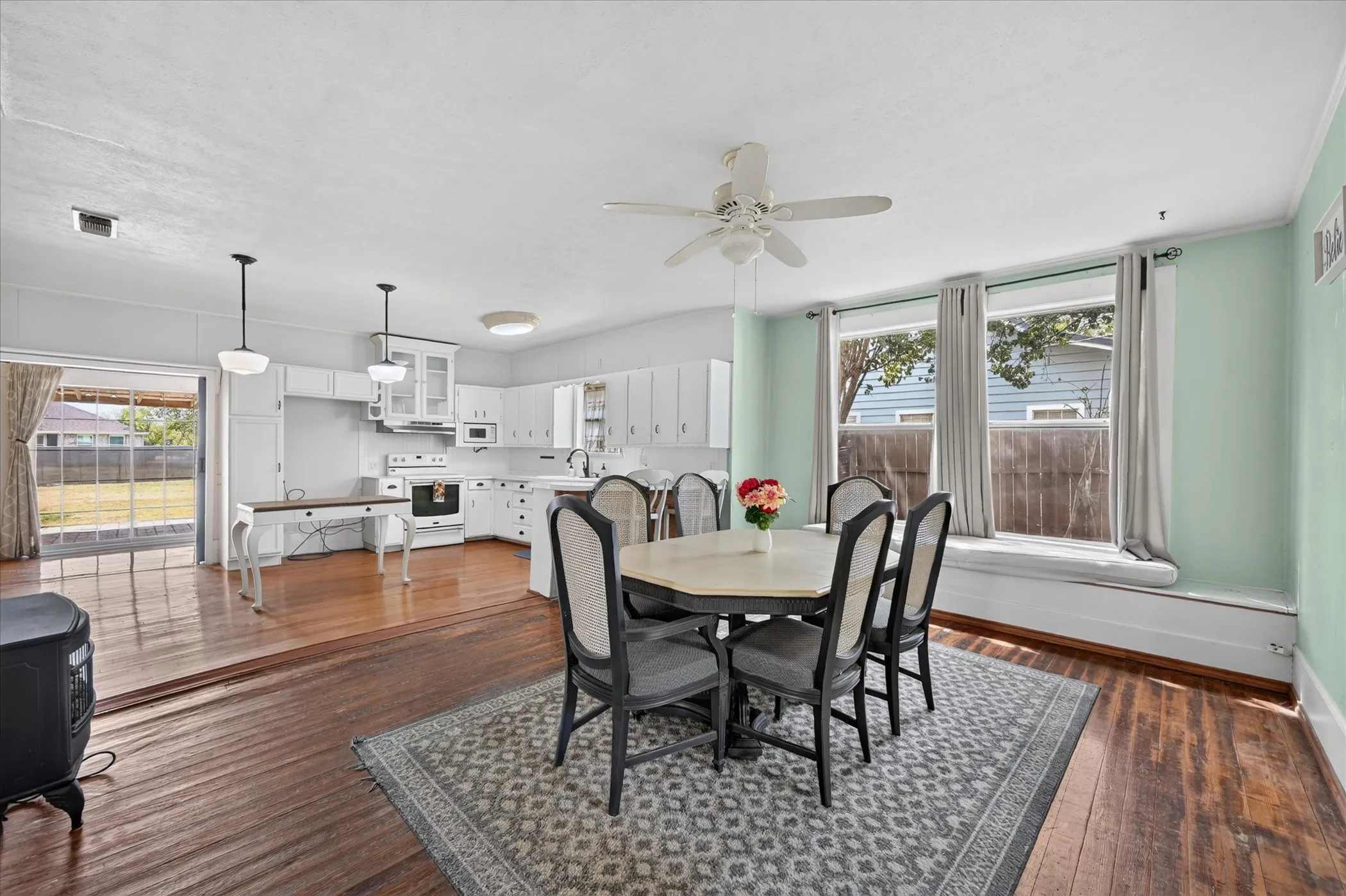 Kitchen area with white cabinetry, stainless steel oven, and recessed lighting
