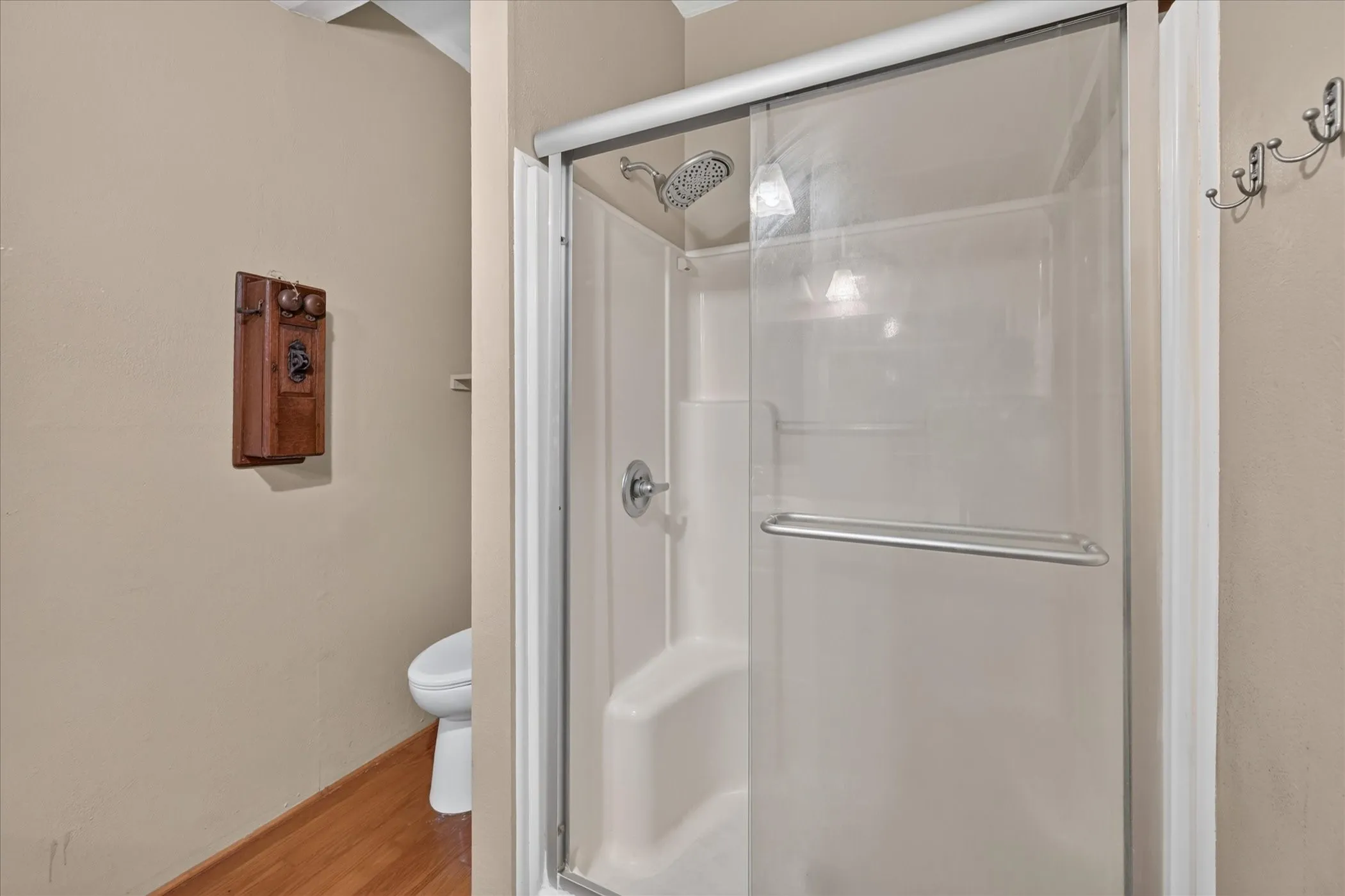 Shower enclosure with clear glass door, chrome hardware, and a rainfall showerhead