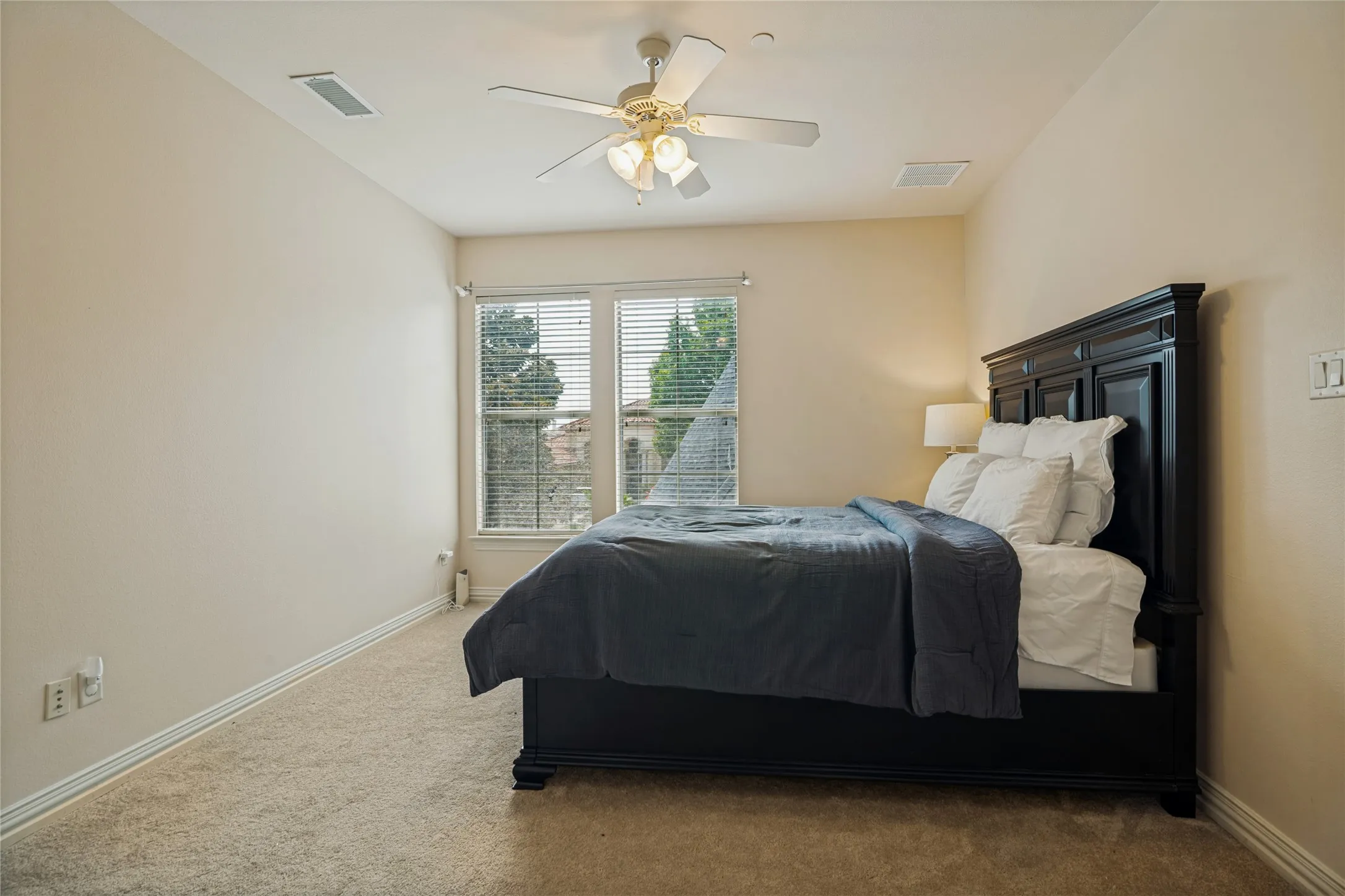 Carpeted flooring, vaulted ceiling, and a ceiling fan with integrated lighting