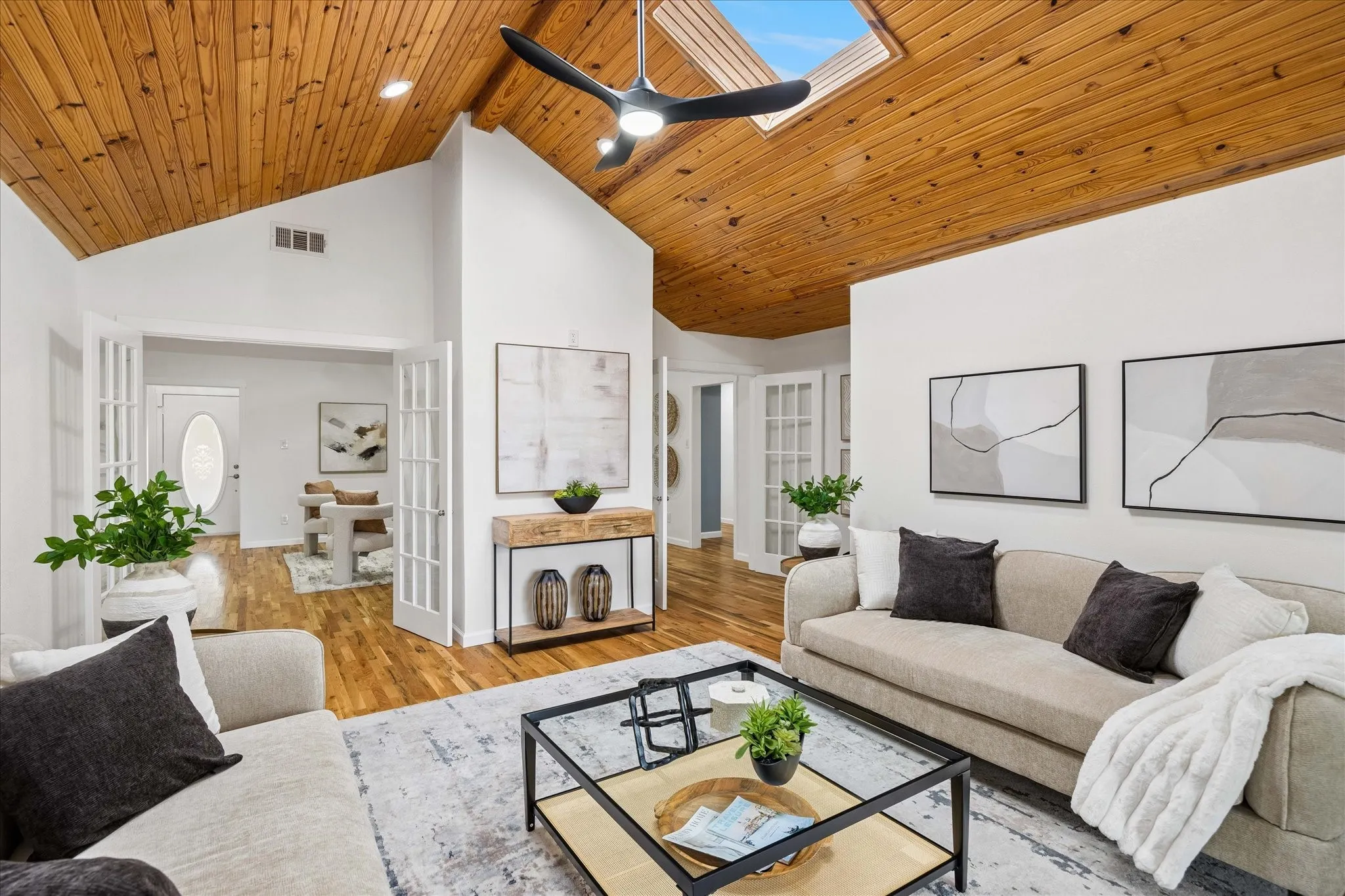 Vaulted ceilings in the sun room looking out onto peaceful acreage.
