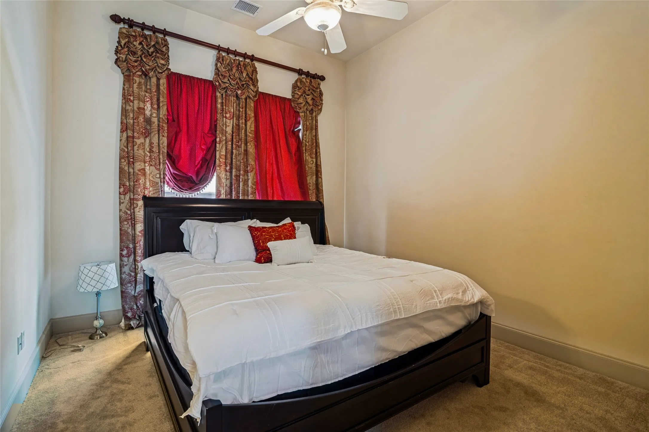 Carpeted room featuring a ceiling fan, wall-to-wall carpeting, and neutral wall tones