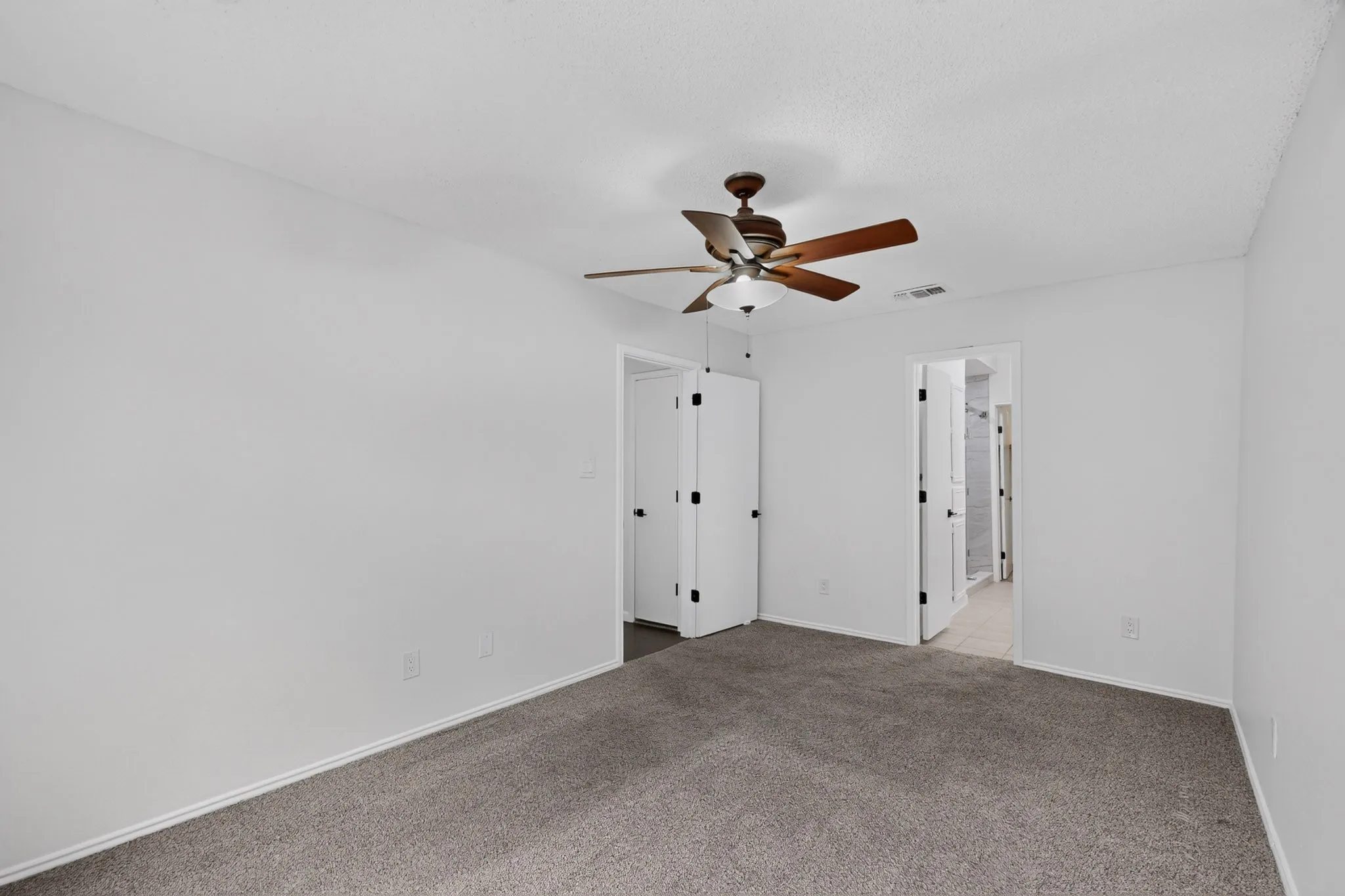 Recessed ceiling fan with light fixture, gray carpet flooring, white walls, and white trim