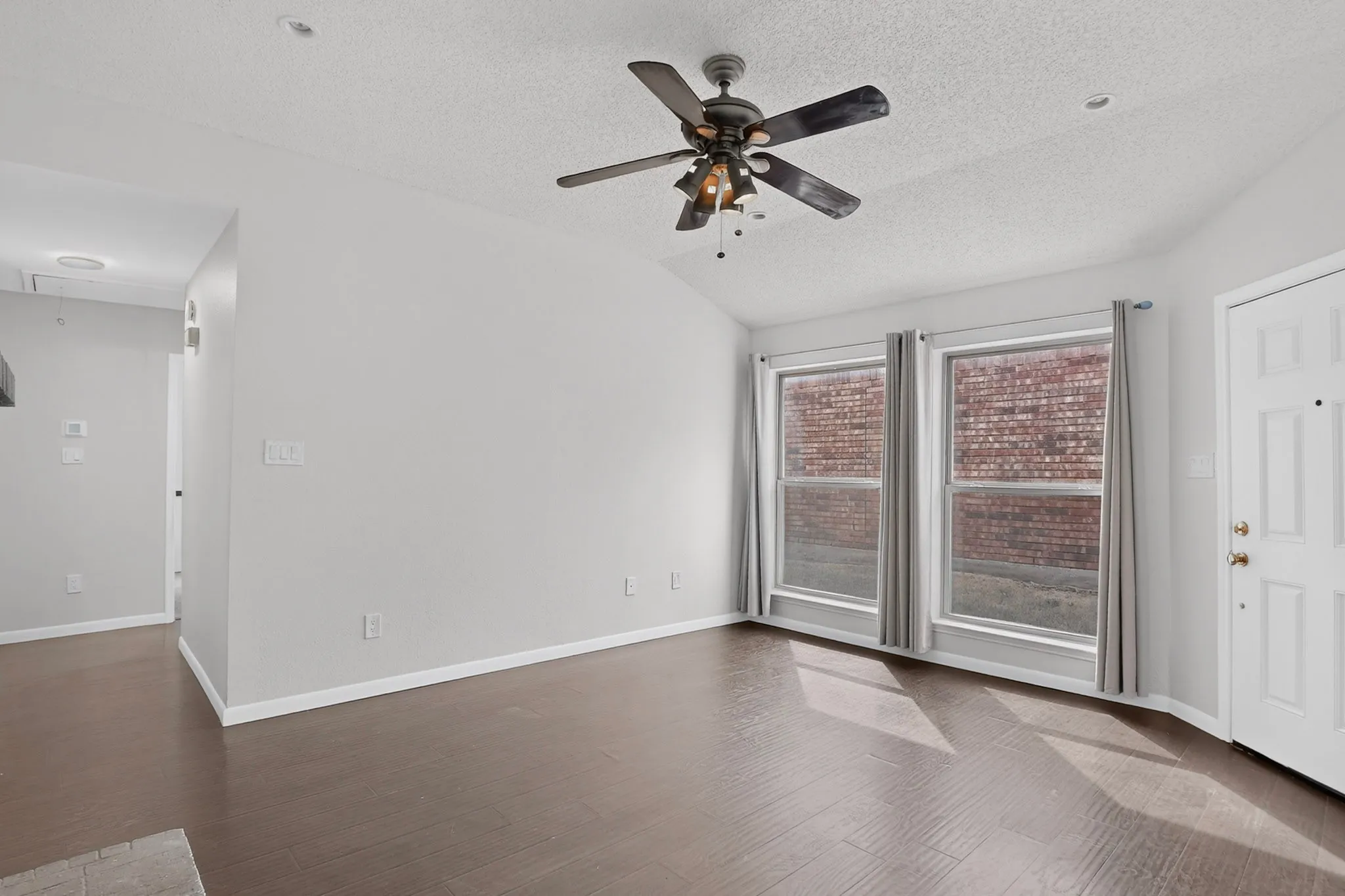 Wood-finish flooring, vaulted ceiling, and recessed lighting