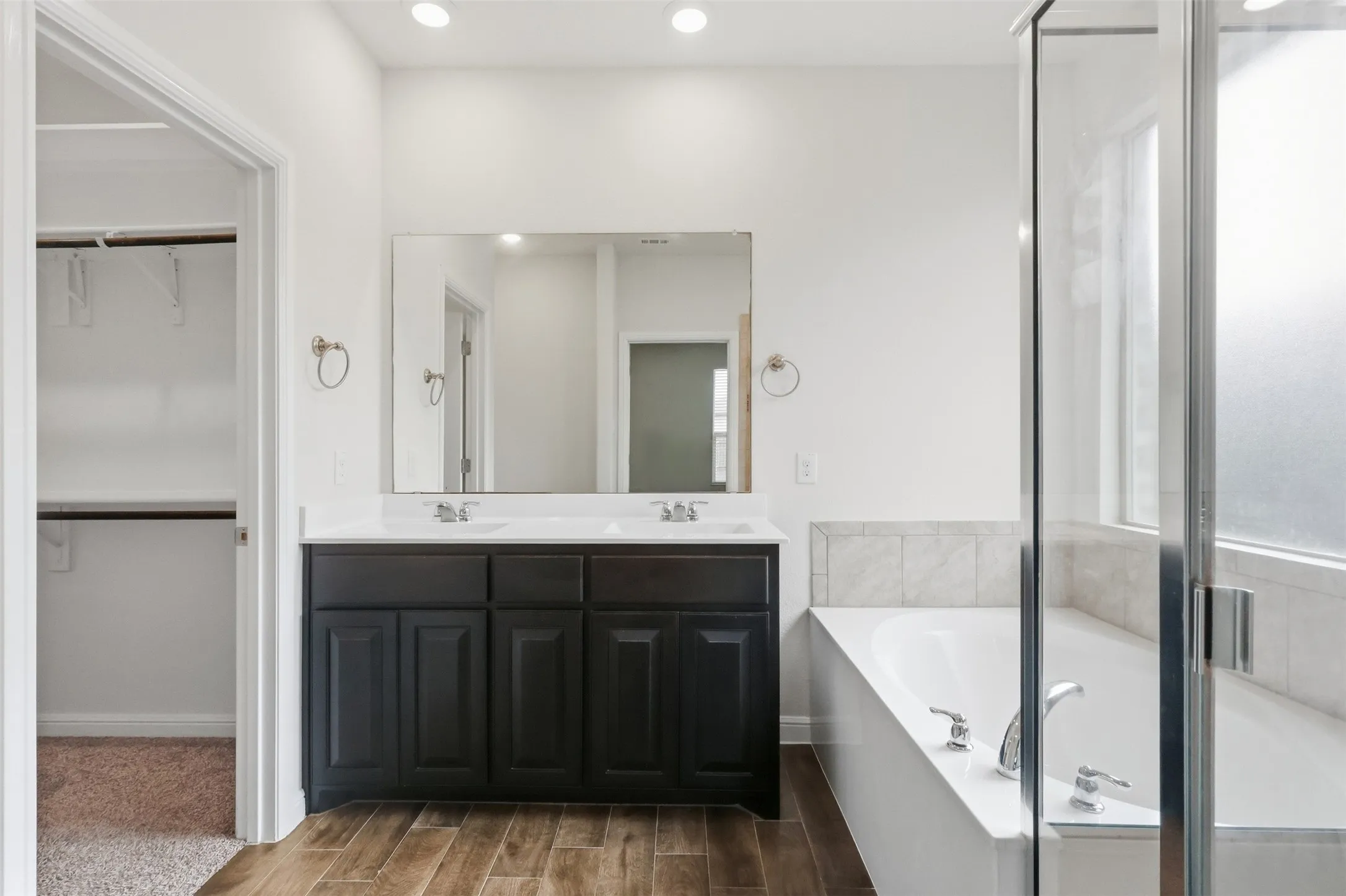 Dual vanity with dark cabinetry and white countertops