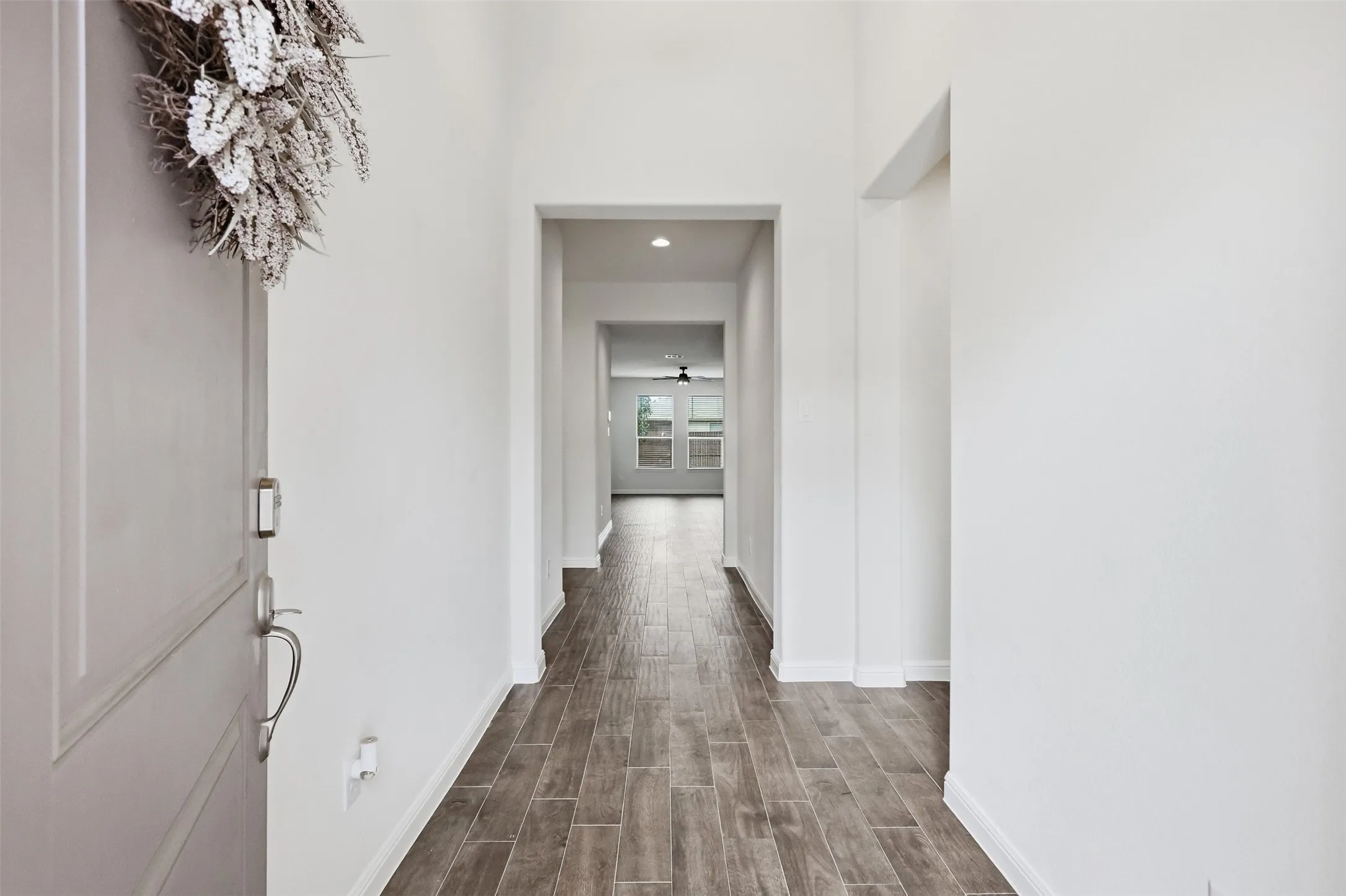 Recessed lighting illuminates the entryway, featuring Tile flooring and a light-toned interior door with brushed nickel hardware