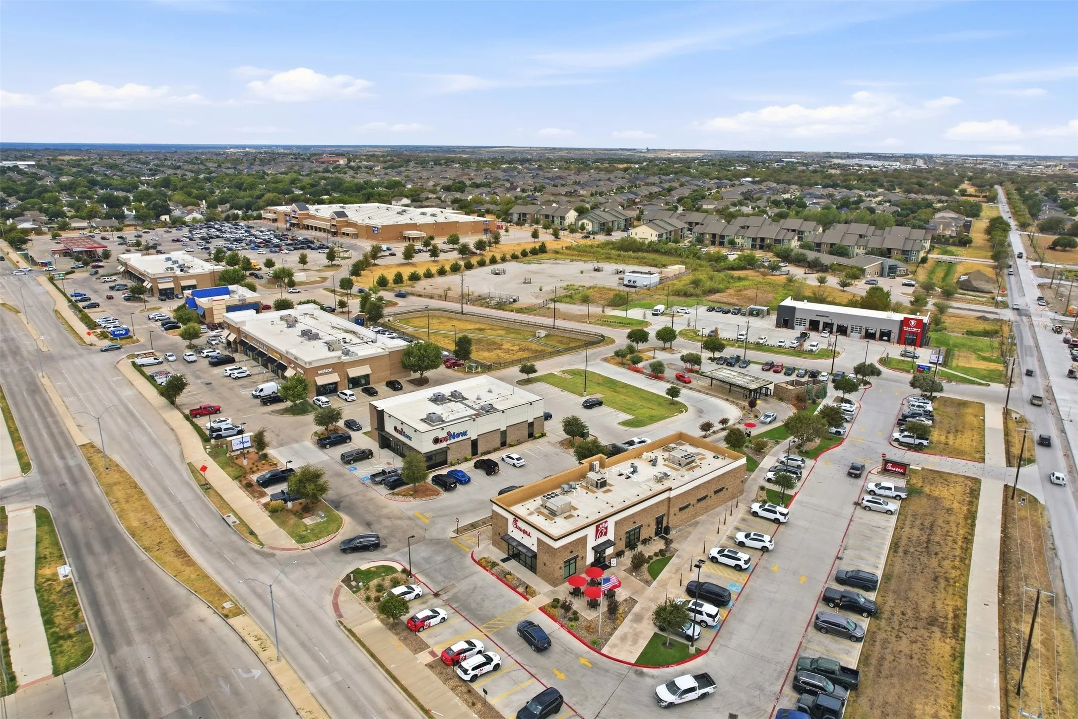 Commercial retail center with ample surface parking, multiple storefronts, and direct road access
