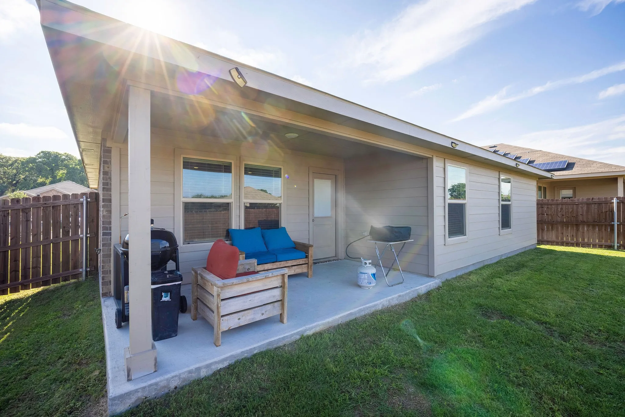 Rear view of house with a patio, a fenced backyard, and an outdoor living space