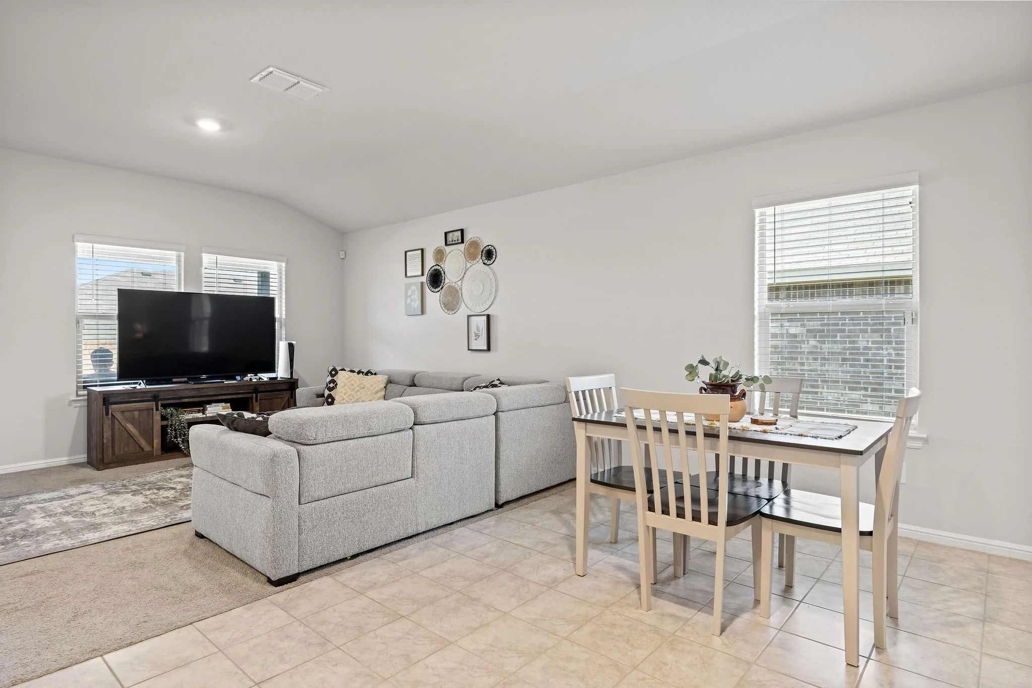 Living room with lofted ceiling and recessed lighting