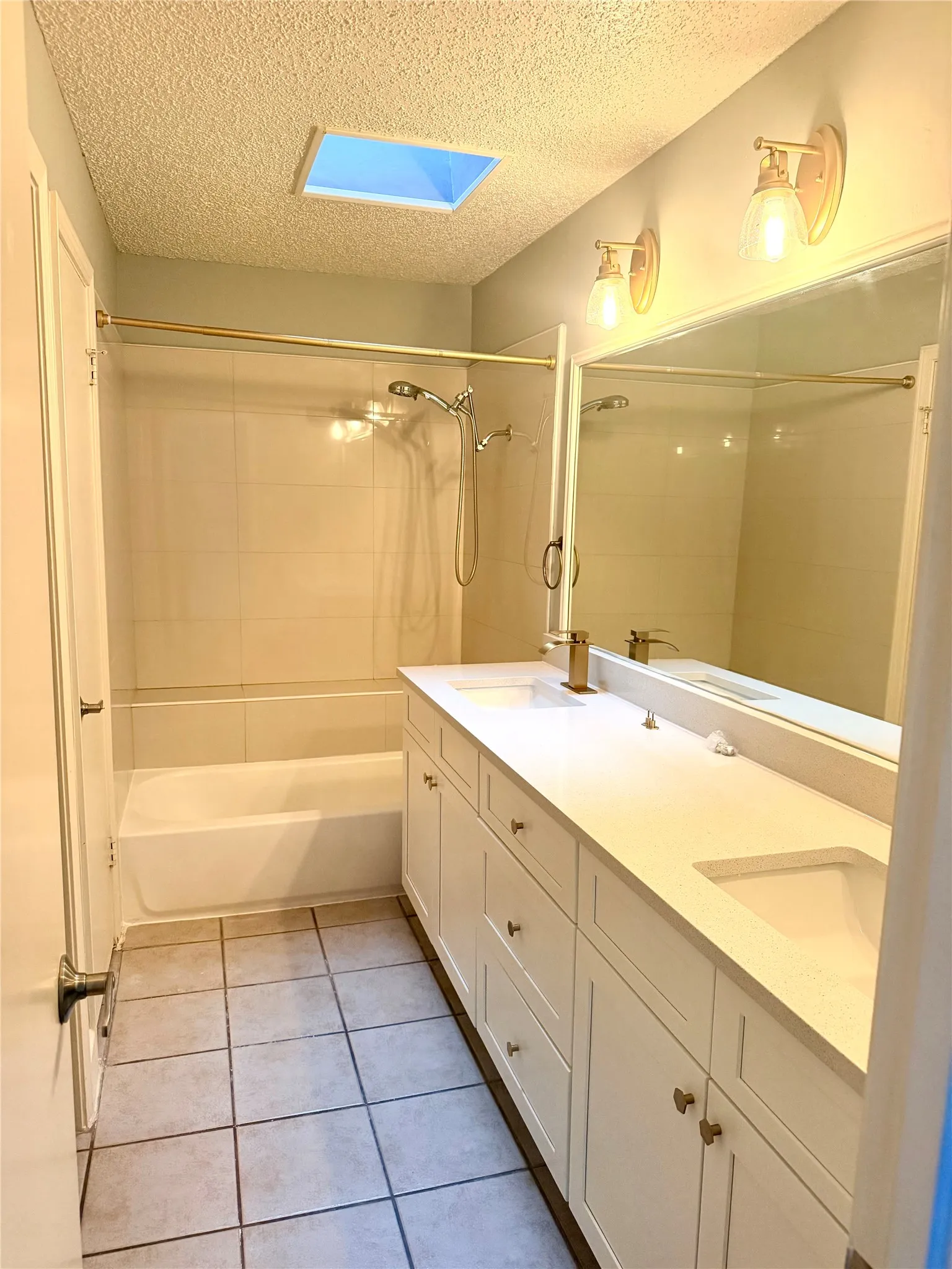Dual vanity with integrated sinks, white cabinetry, and a light-toned countertop