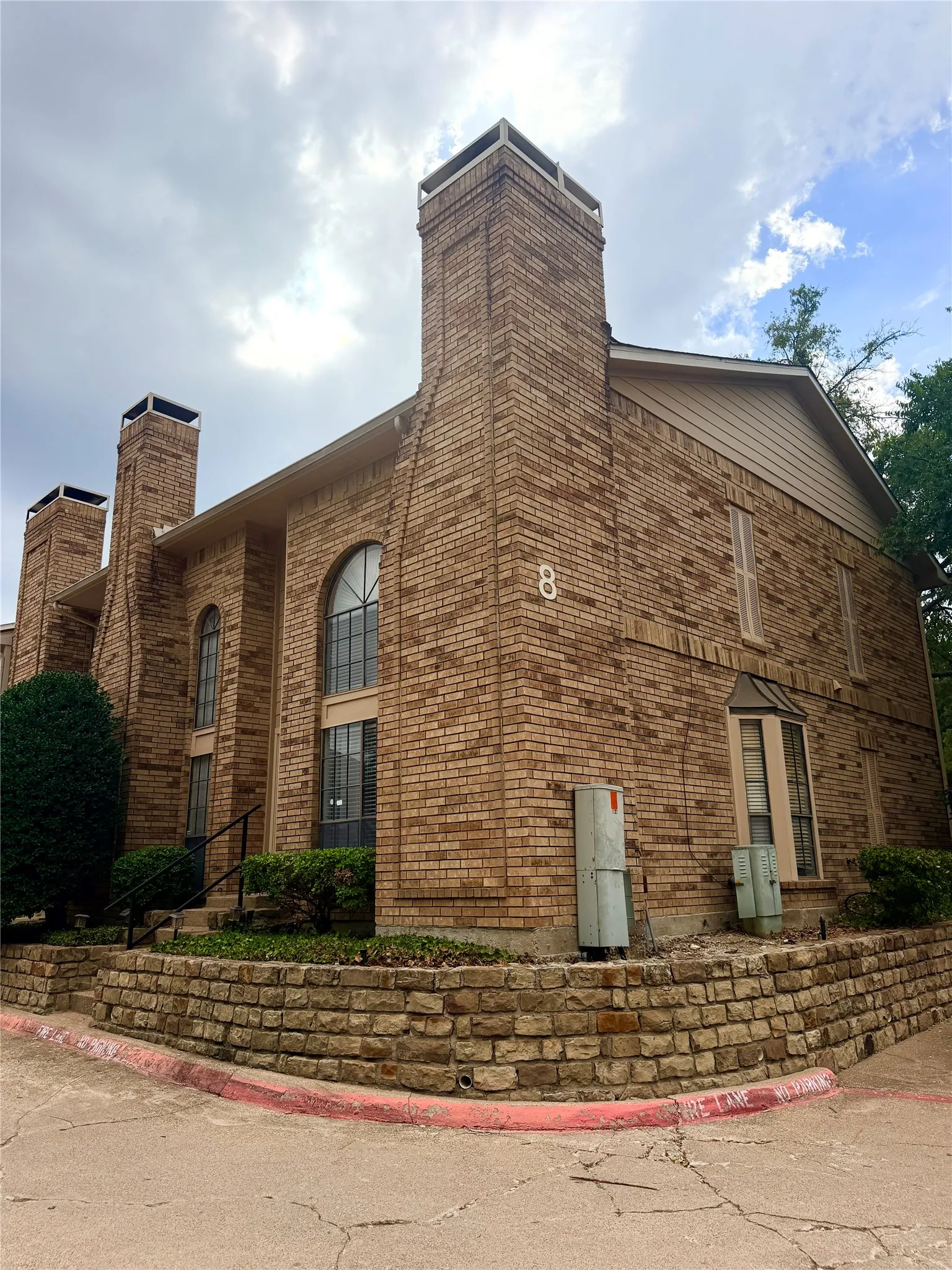 Brick exterior construction featuring multiple chimneys
