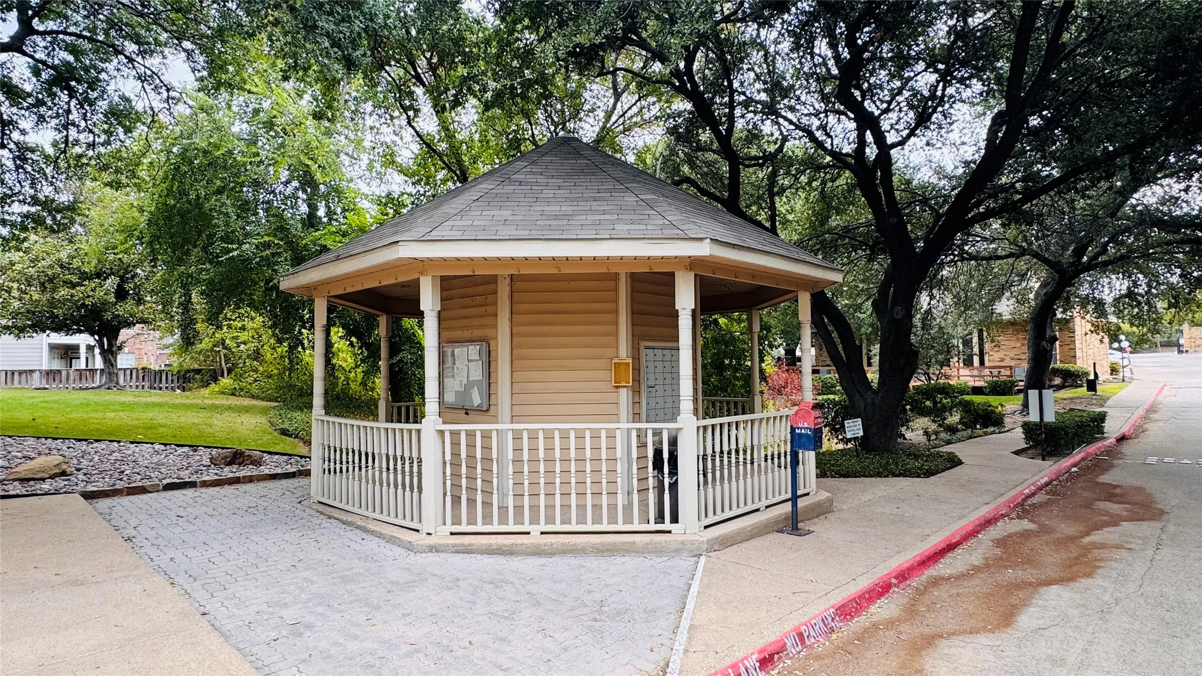 Hexagonal gazebo with siding exterior, shingle roof, and white railing