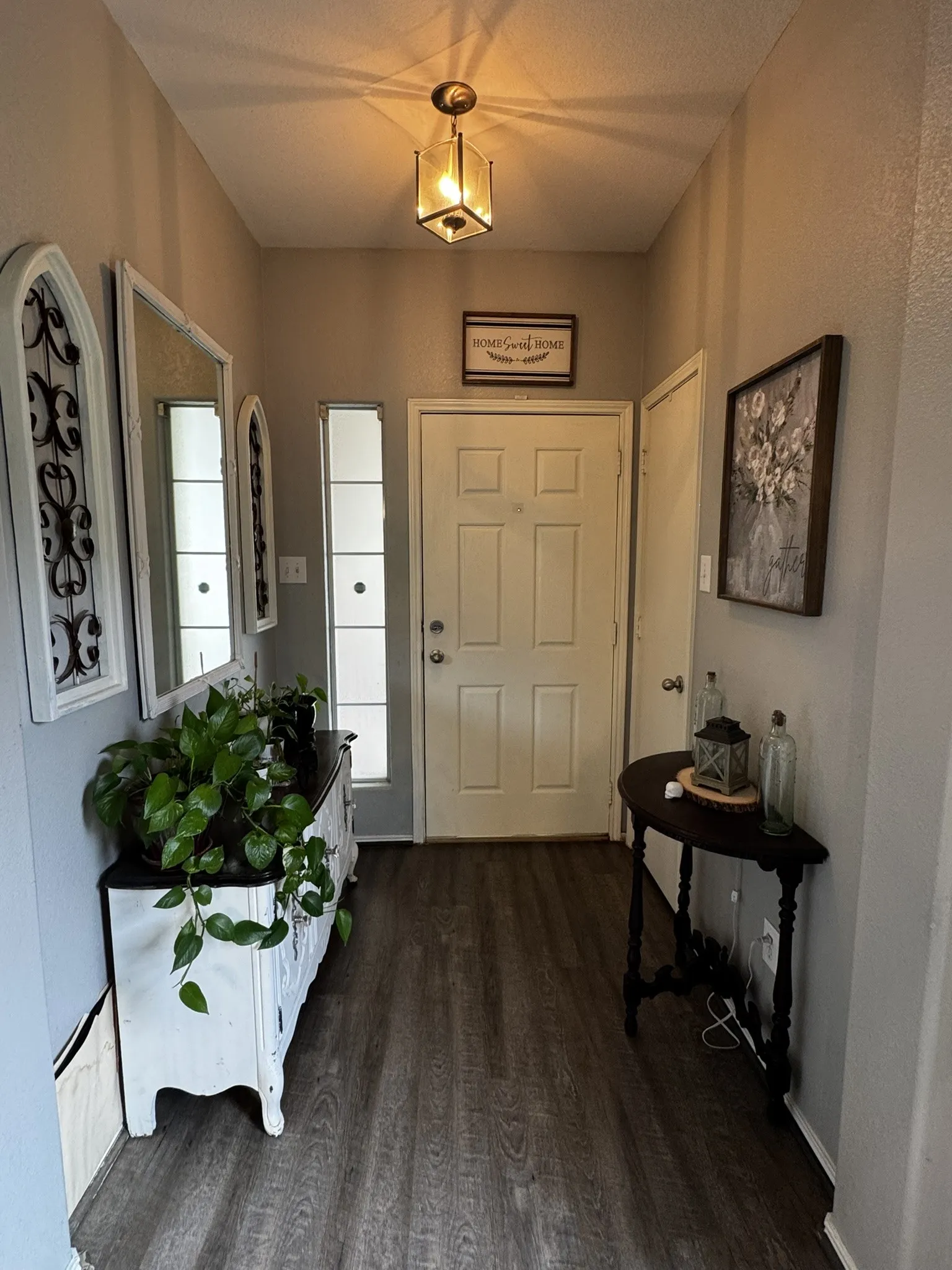 Entryway featuring wood-finish flooring, a neutral wall color, and a ceiling-mounted light fixture