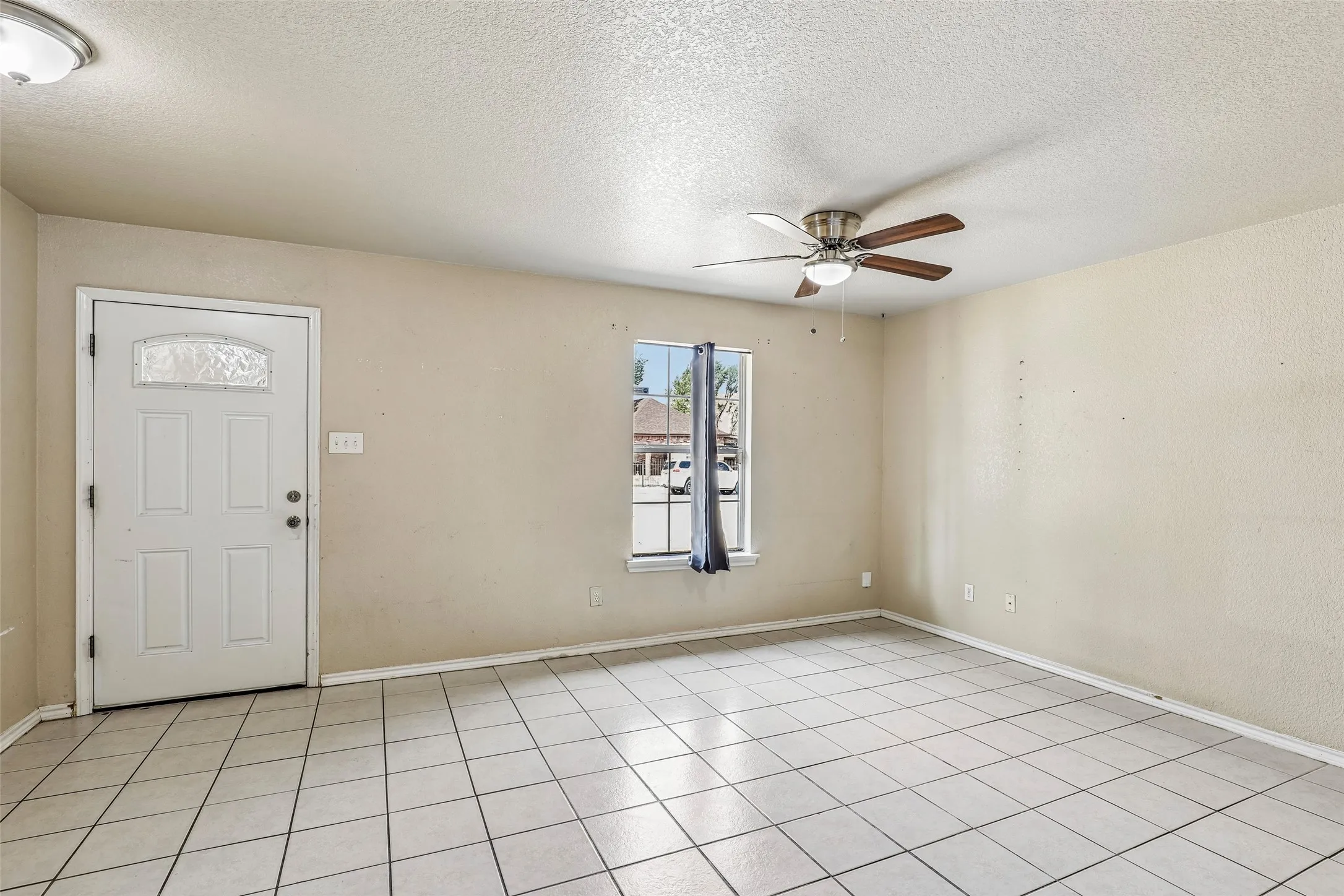 Unit 101 living room with durable tile flooring