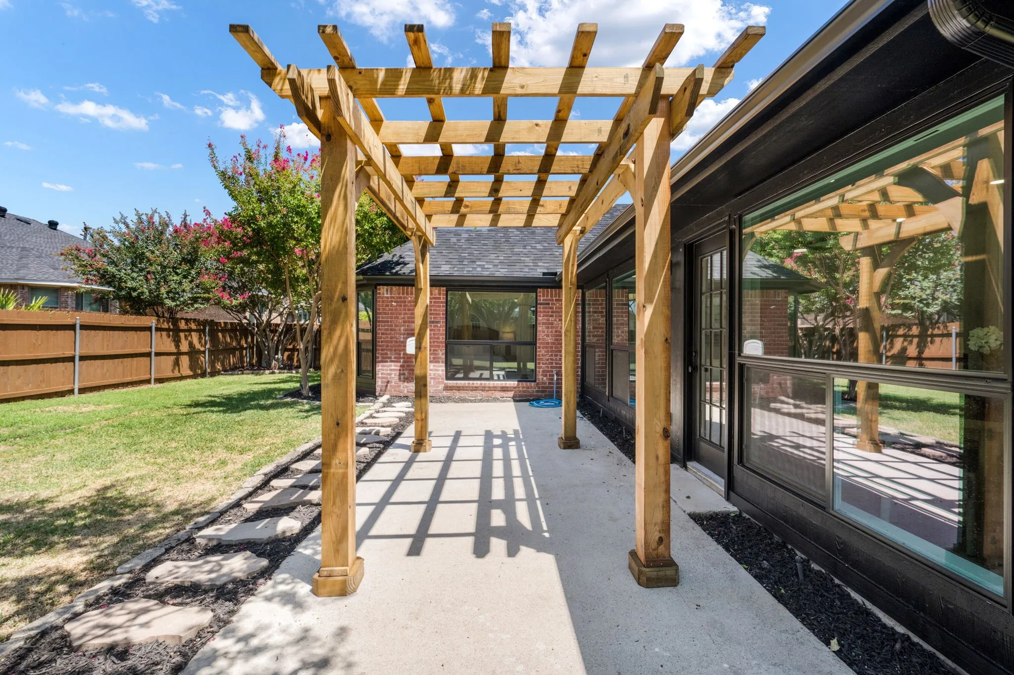 Wood pergola structure over a concrete patio