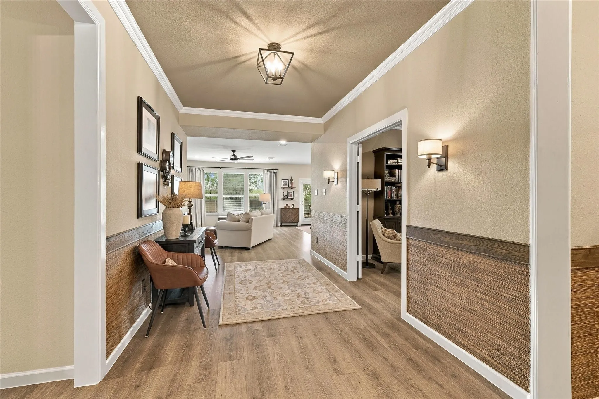 An impressive entry corridor draws you into the heart of the home, pairing warm finishes and architectural detail with an open, flowing floor plan.