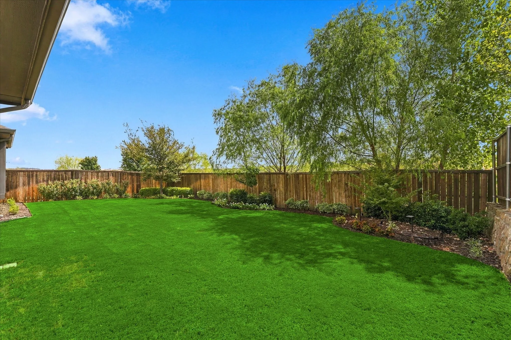 A lush, private backyard creates your own outdoor escape, surrounded by mature landscaping, established trees and beautifully maintained garden beds.