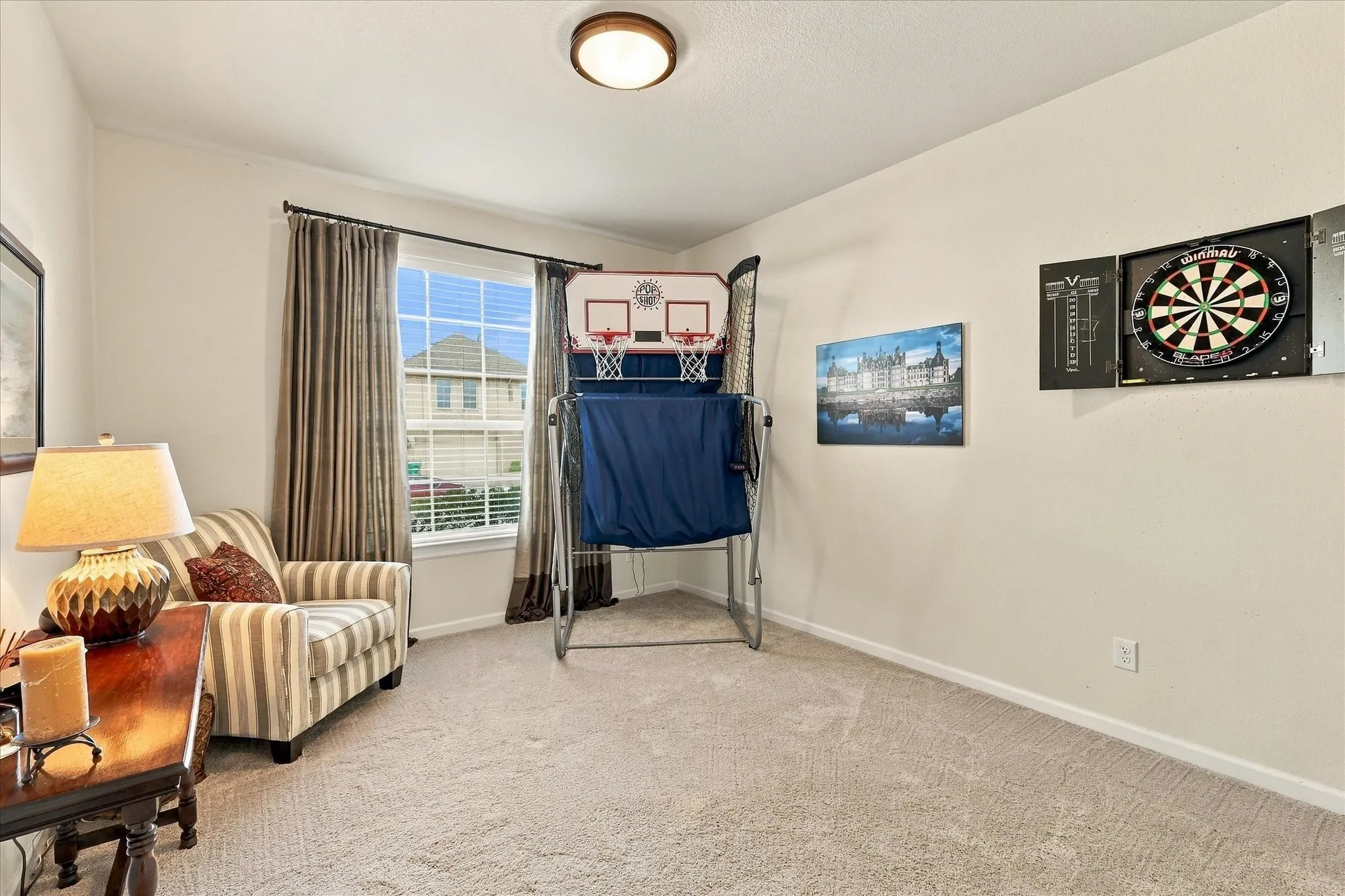 Another secondary bedroom that is nicely designed with drapes, neutral colors and a walk in closet.