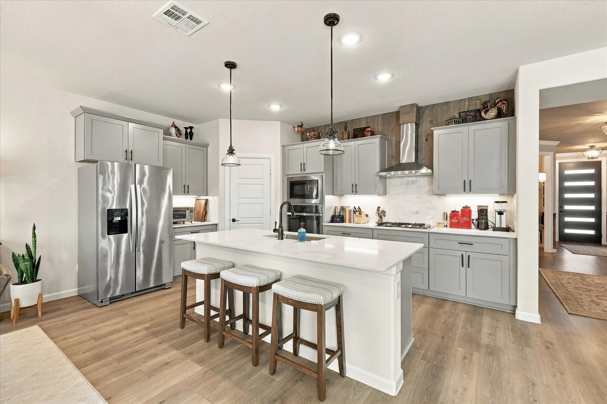 Cook, entertain and enjoy with a beautifully equipped kitchen featuring built-in stainless appliances, extensive counter space and thoughtfully designed storage.