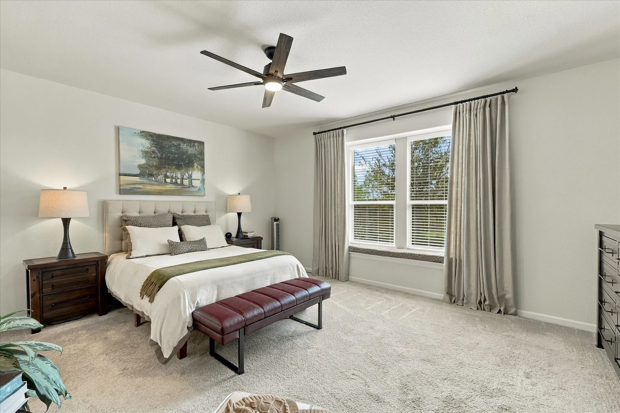 The oversized primary suite is a relaxing retreat, filled with natural light and offering plenty of space for substantial bedroom furniture and a sitting area.