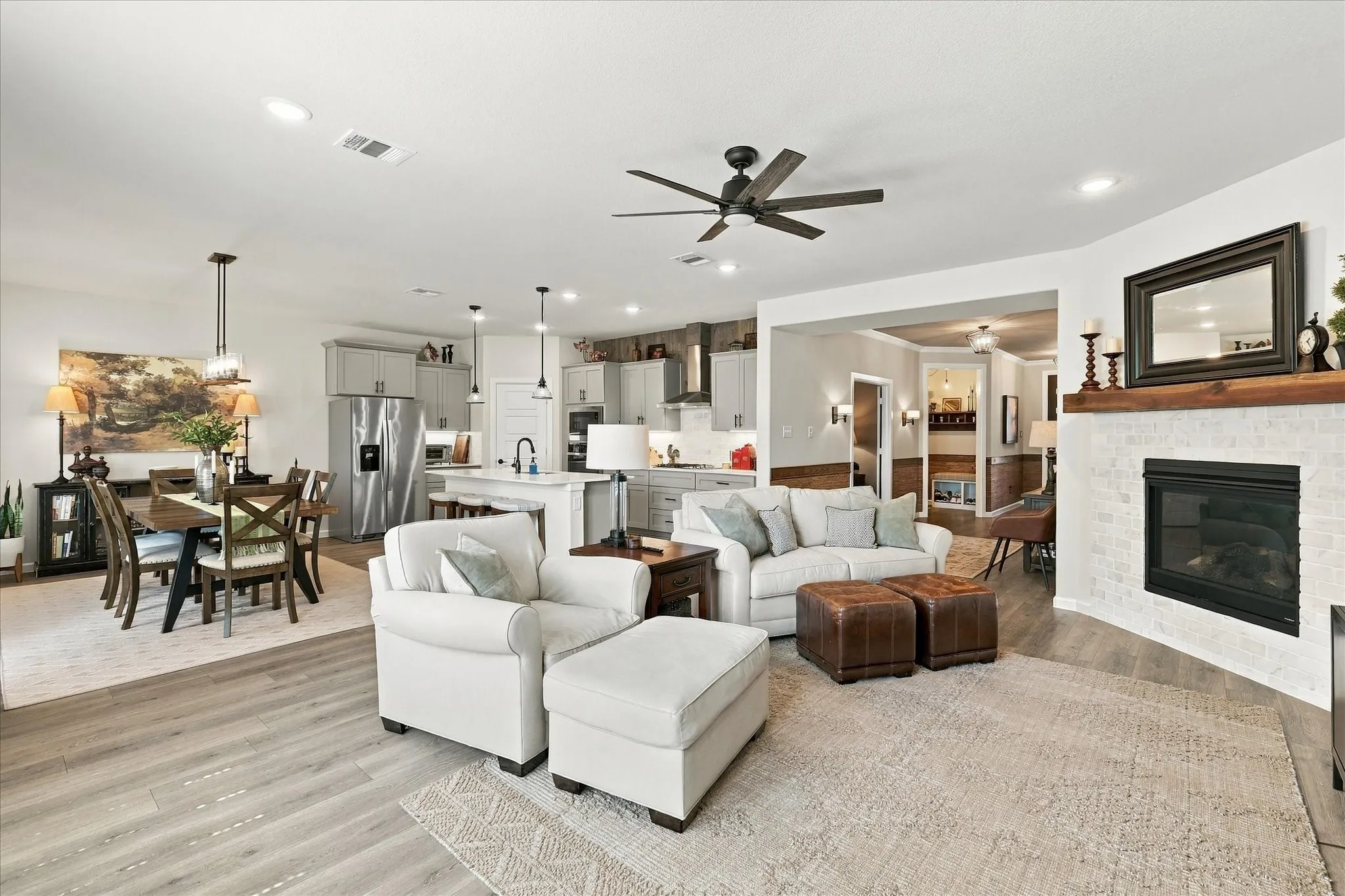 Relax in a beautifully appointed family room featuring a statement fireplace, abundant natural light and seamless connection to the surrounding dining spaces.