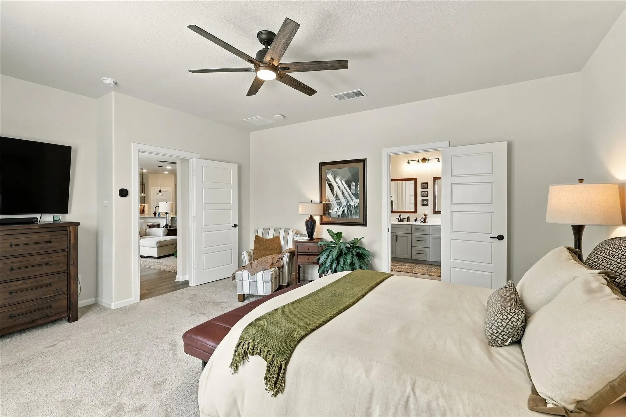 A true owner’s retreat, the primary suite features generous dimensions and convenient private access to the ensuite bath.